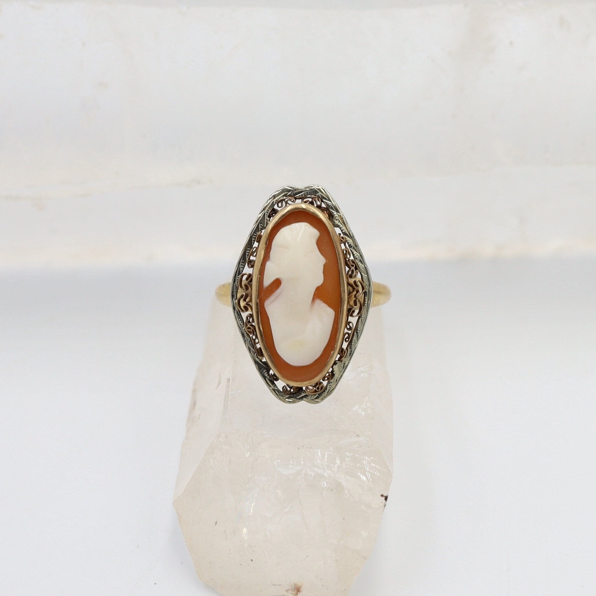 Victorian 10k gold shell cameo ring with intricate cannetille detailing, showcasing a classic vintage jewelry design