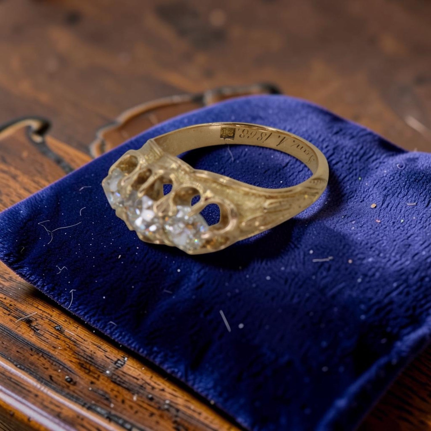 Antique Victorian 3 stone diamond ring featuring 0.93ct old mine cut diamonds, engraved date 1868, in 18K gold vintage band.