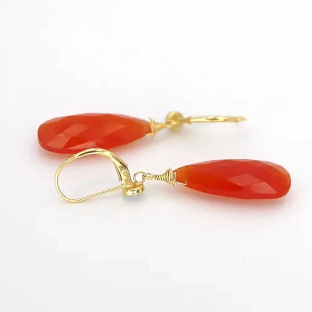 Petra Star Firestarter earrings featuring fiery orange and red gemstone accents, dangling gold-tone earring design.
