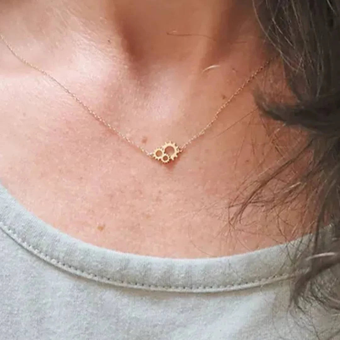 Petra Star Gearhead Necklace featuring a sleek, modern design with metallic gear-shaped pendant on a delicate chain.