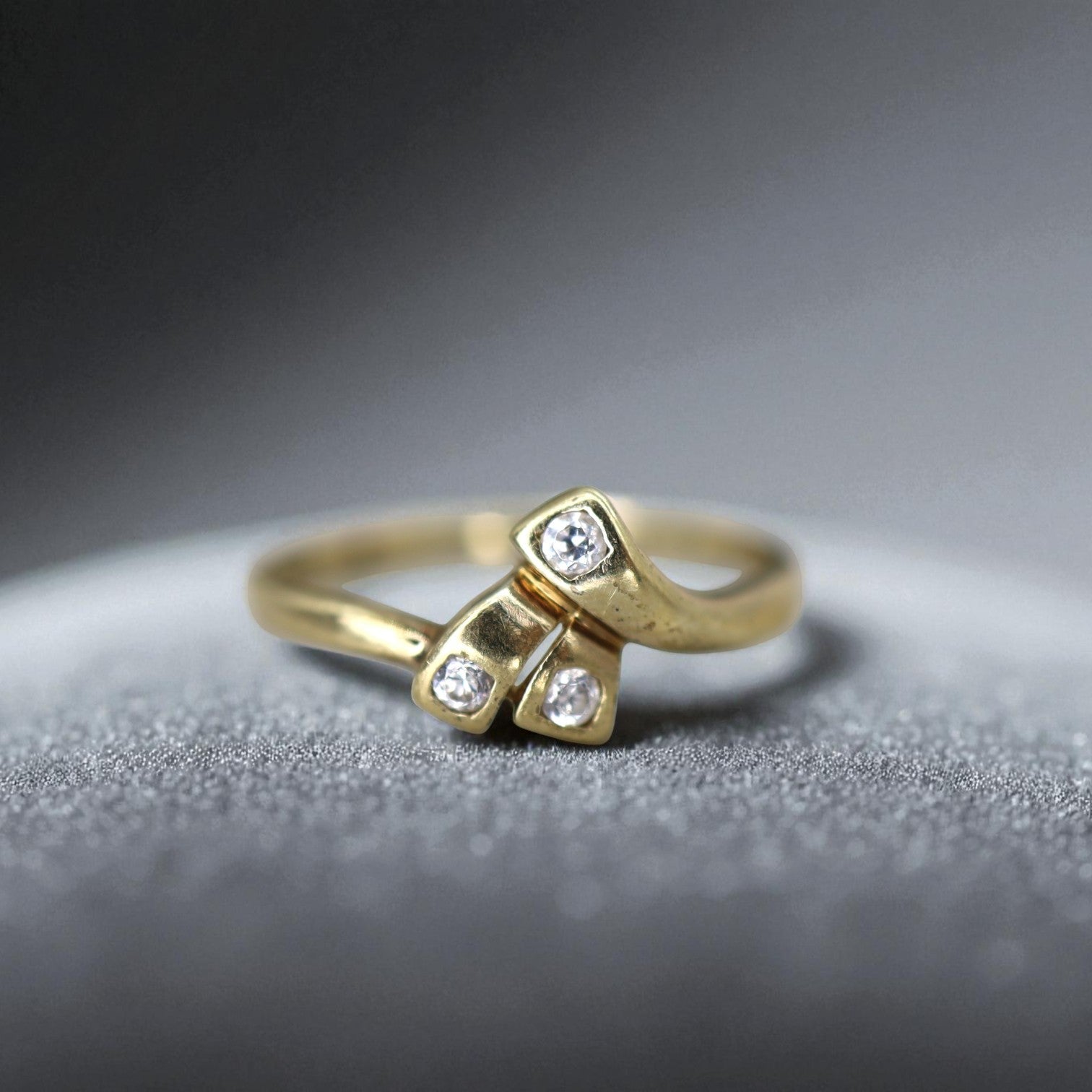 9k Gold Mid-Century Asymmetrical Ribbon Three-Stone Cubic Zirconia Ring - Petra Star