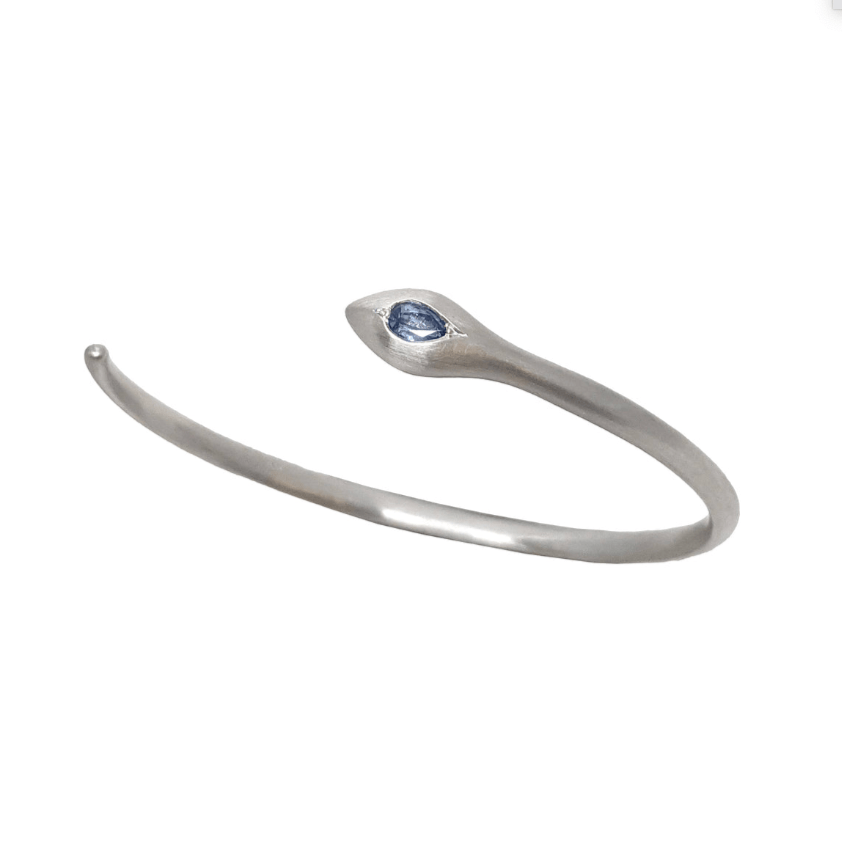 Dan-Yell Apep Montana Blue Sapphire bracelet featuring a sleek cuff design with vibrant blue sapphires and silver accents.