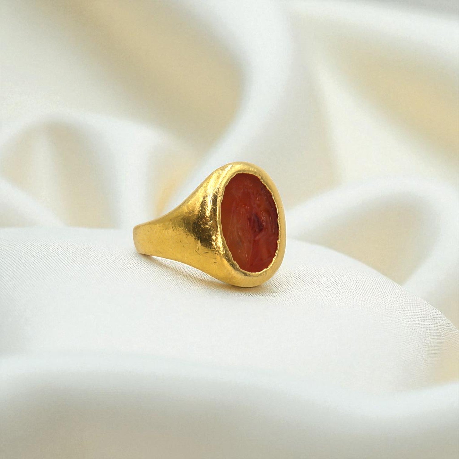 Antique carnelian intaglio ring in 22k gold featuring intricate carved gemstone and vintage design.