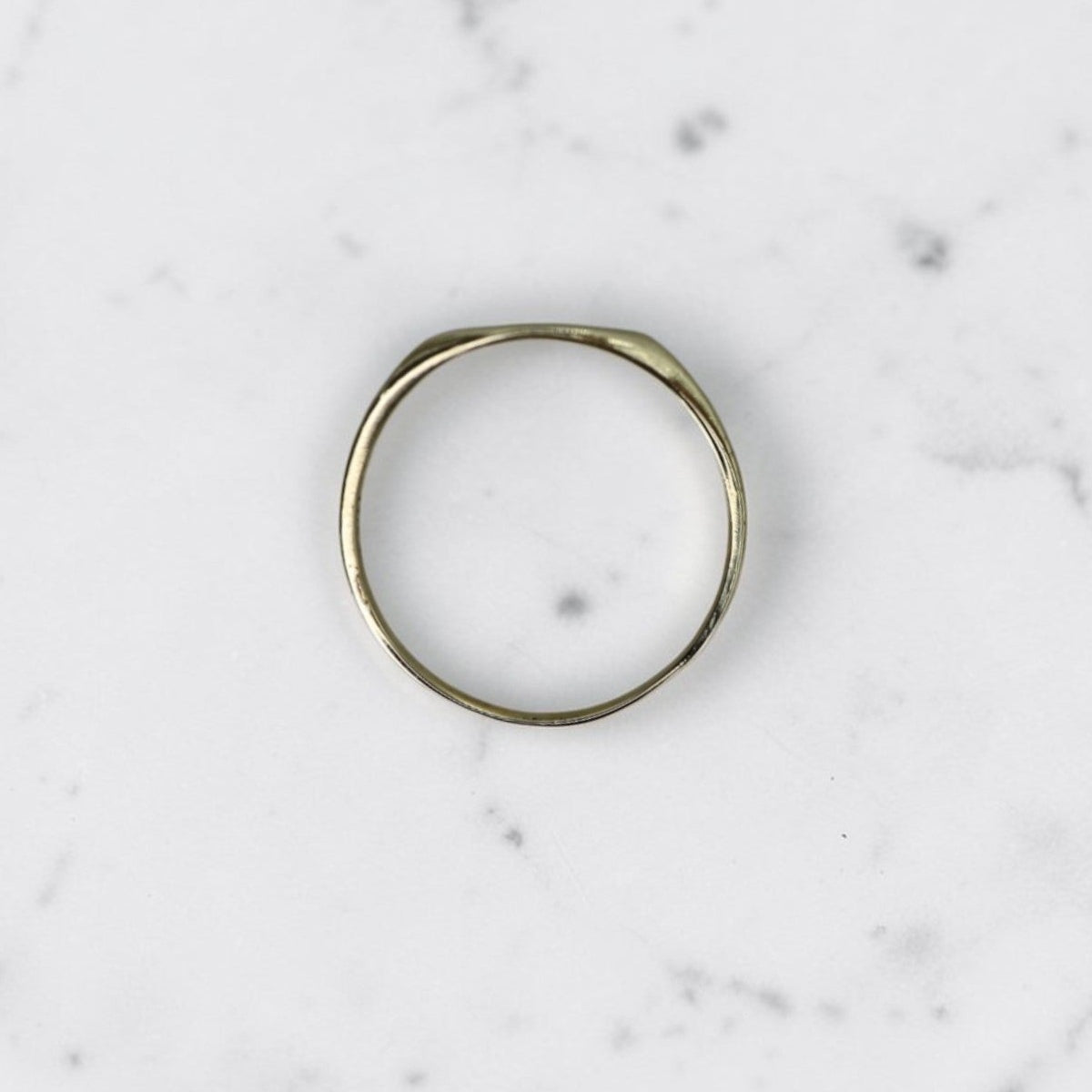 Edwardian Ostby & Barton signet ring in 10k yellow gold, worn on pinky finger, vintage jewelry with engraved design.