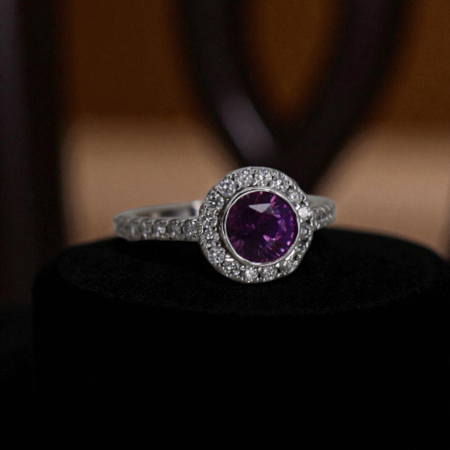 Beautiful purple sapphire halo engagement ring with vintage design, featuring a central purple sapphire surrounded by sparkling diamonds.