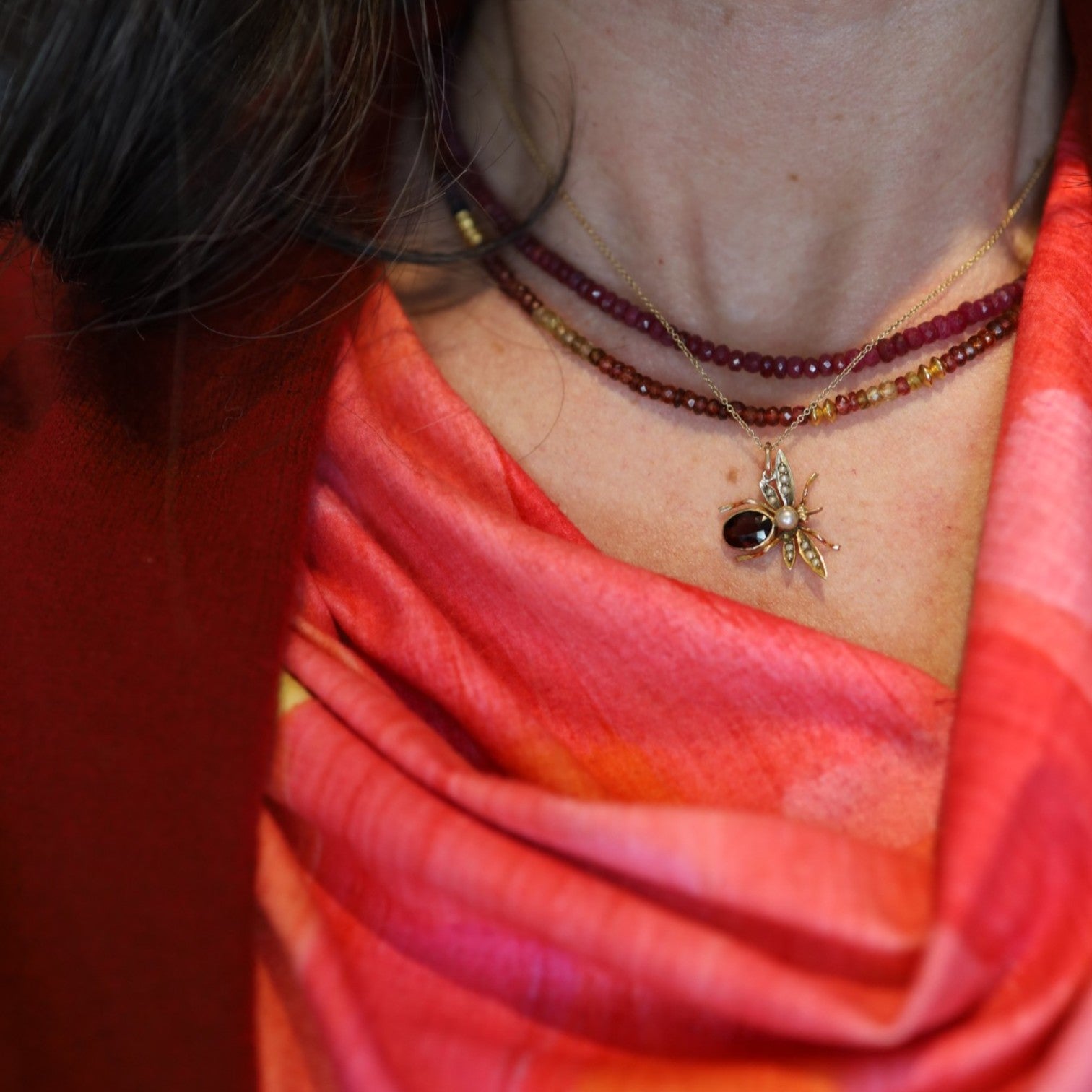 Victorian garnet pearl insect pendant featuring a detailed antique design, showcasing deep red garnets and lustrous pearls.