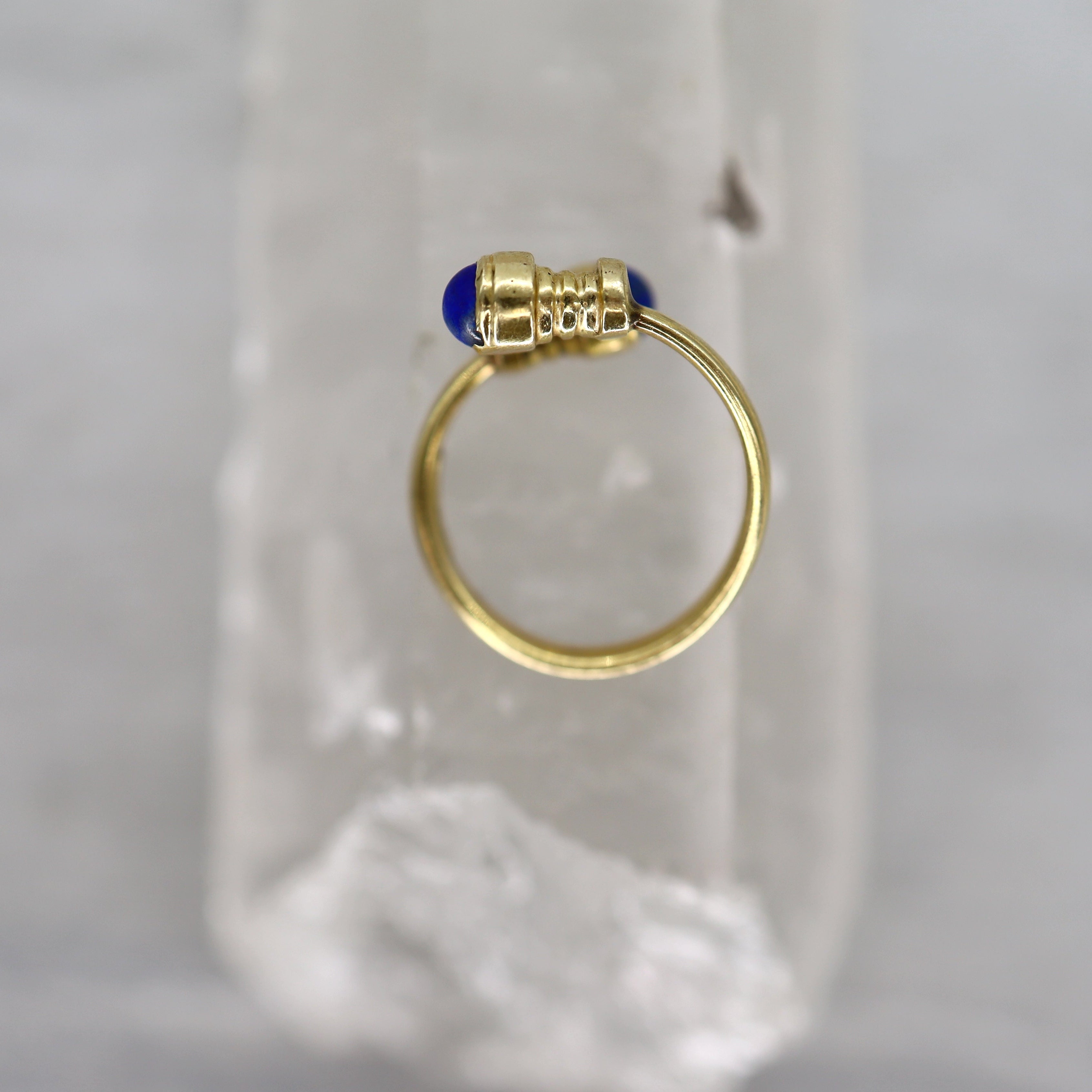 Vintage lapis bypass ring in 14k yellow gold featuring a sleek design and polished finish, showcasing elegant jewelry craftsmanship.