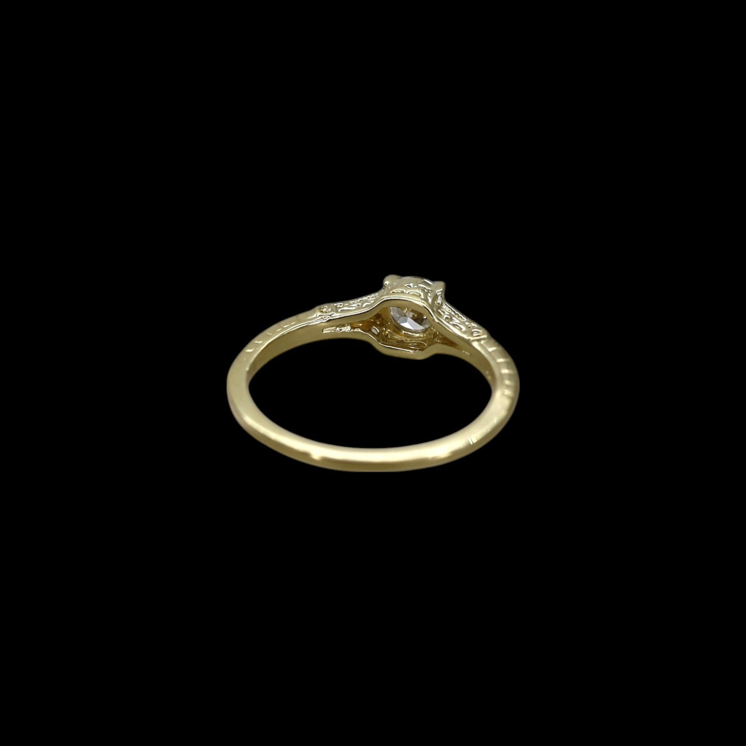 Victorian-inspired solitaire engagement ring with a central gemstone, crafted by Petra Star, featuring intricate vintage design details.
