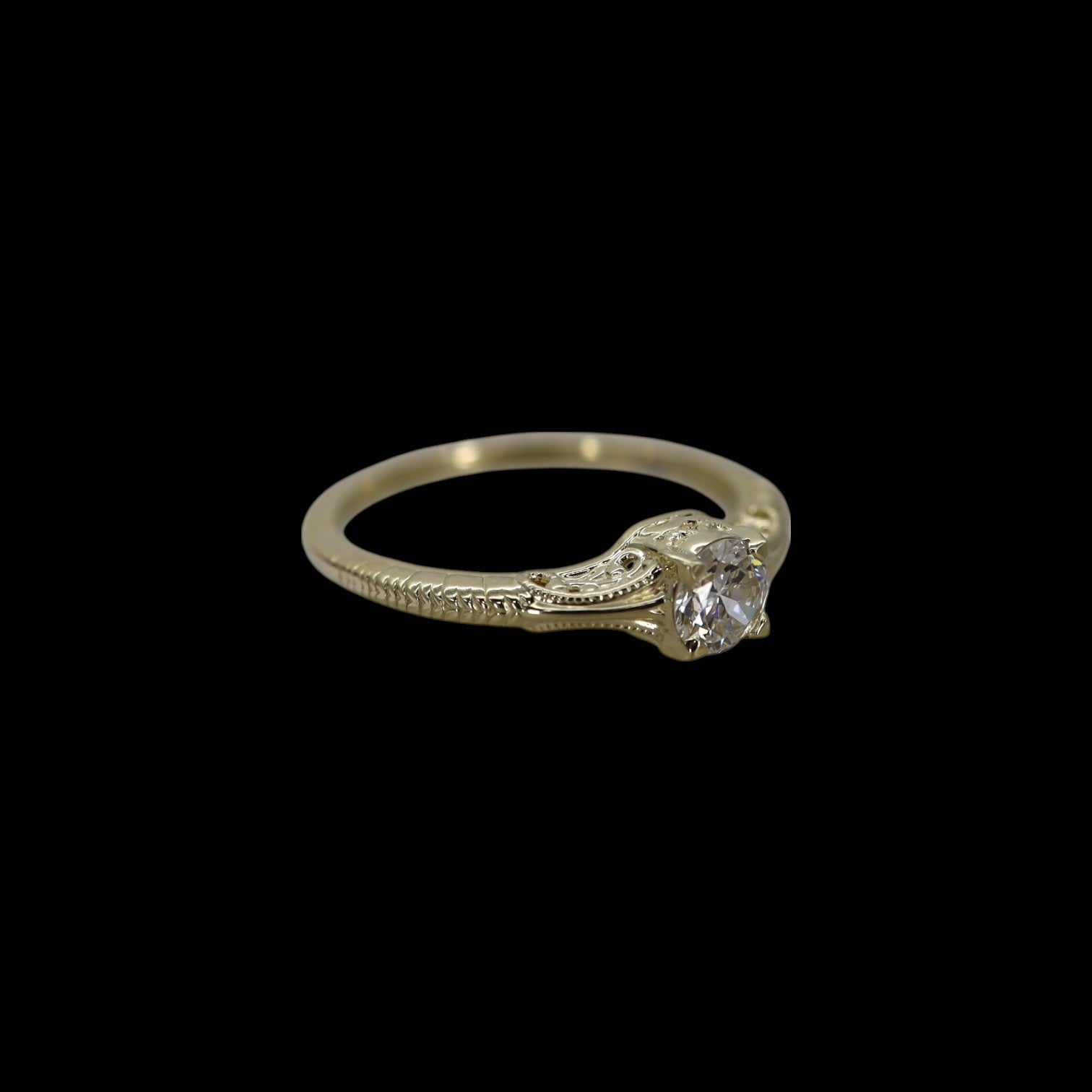 Victorian-inspired solitaire engagement ring by Petra Star featuring a sparkling central gemstone and intricate vintage design.