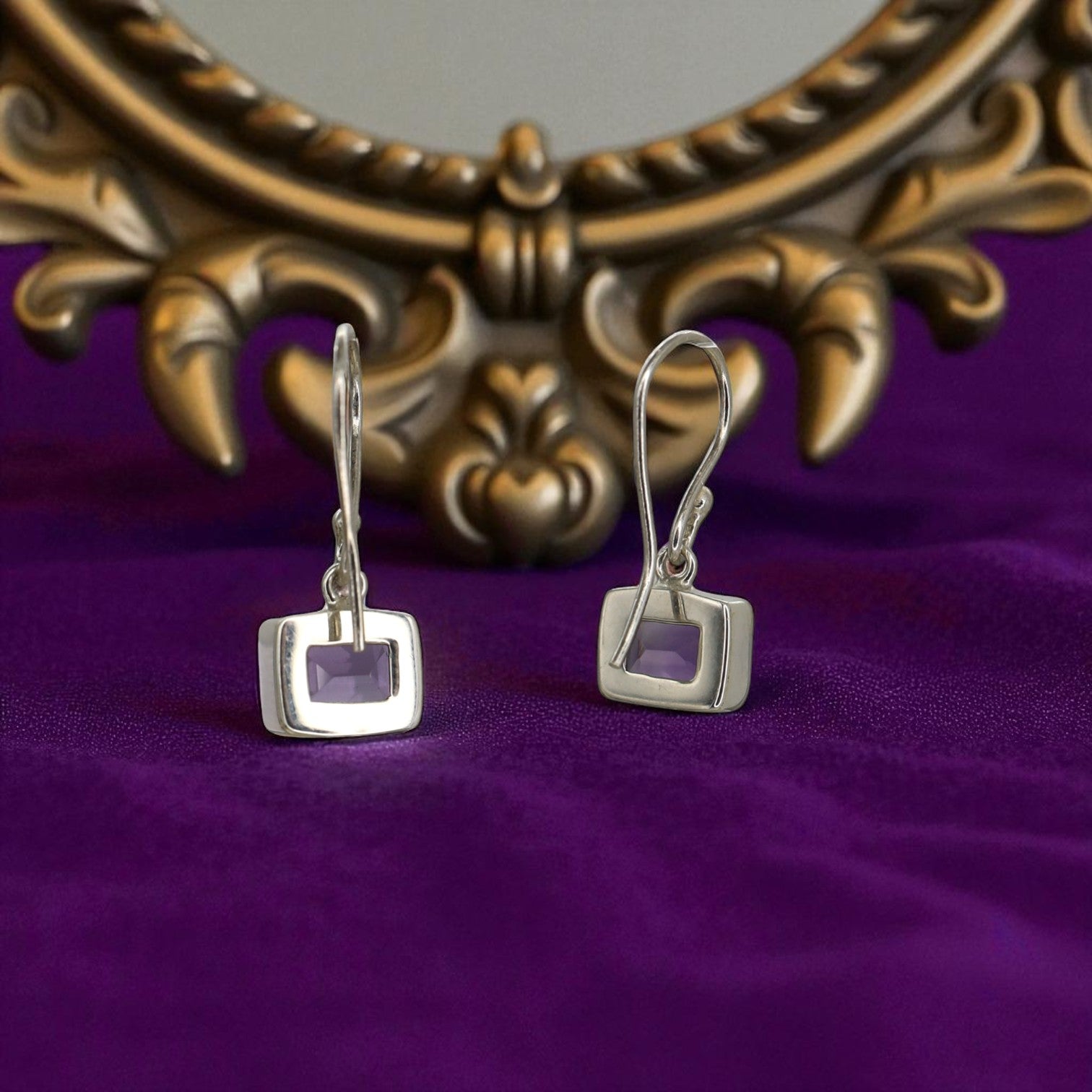 Pair of PS MakeOver earrings featuring stylish, silver-toned hoops with intricate detailing, displayed against a neutral background.