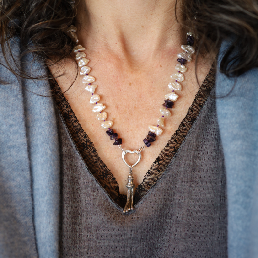 Amethyst and Keshi pearl necklace with silver heart charm clasp, featuring elegant gemstone and pearl beads on a delicate chain.
