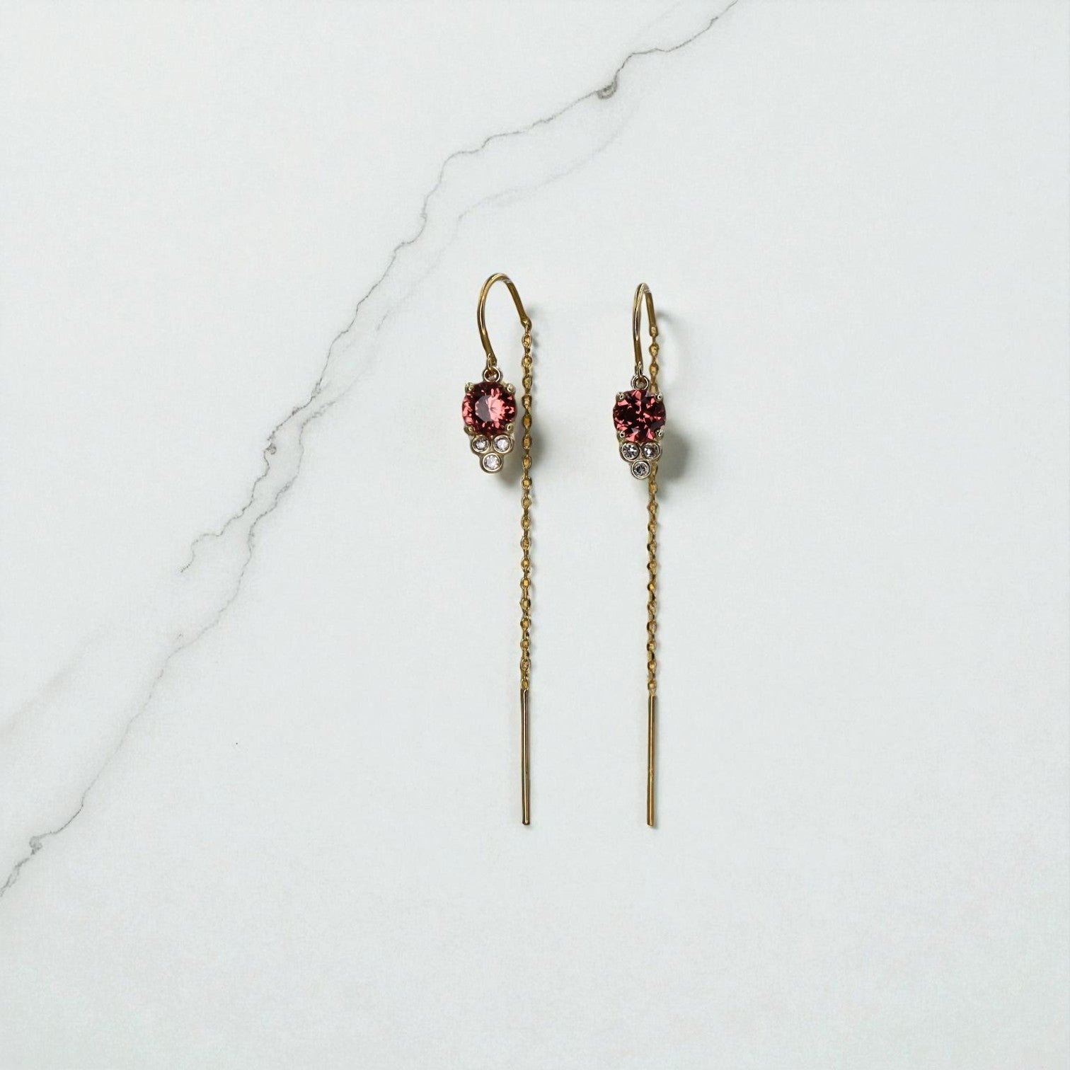 Malayan garnet threader earrings in 14k gold with delicate design, featuring vibrant garnet stones and sleek gold chain.