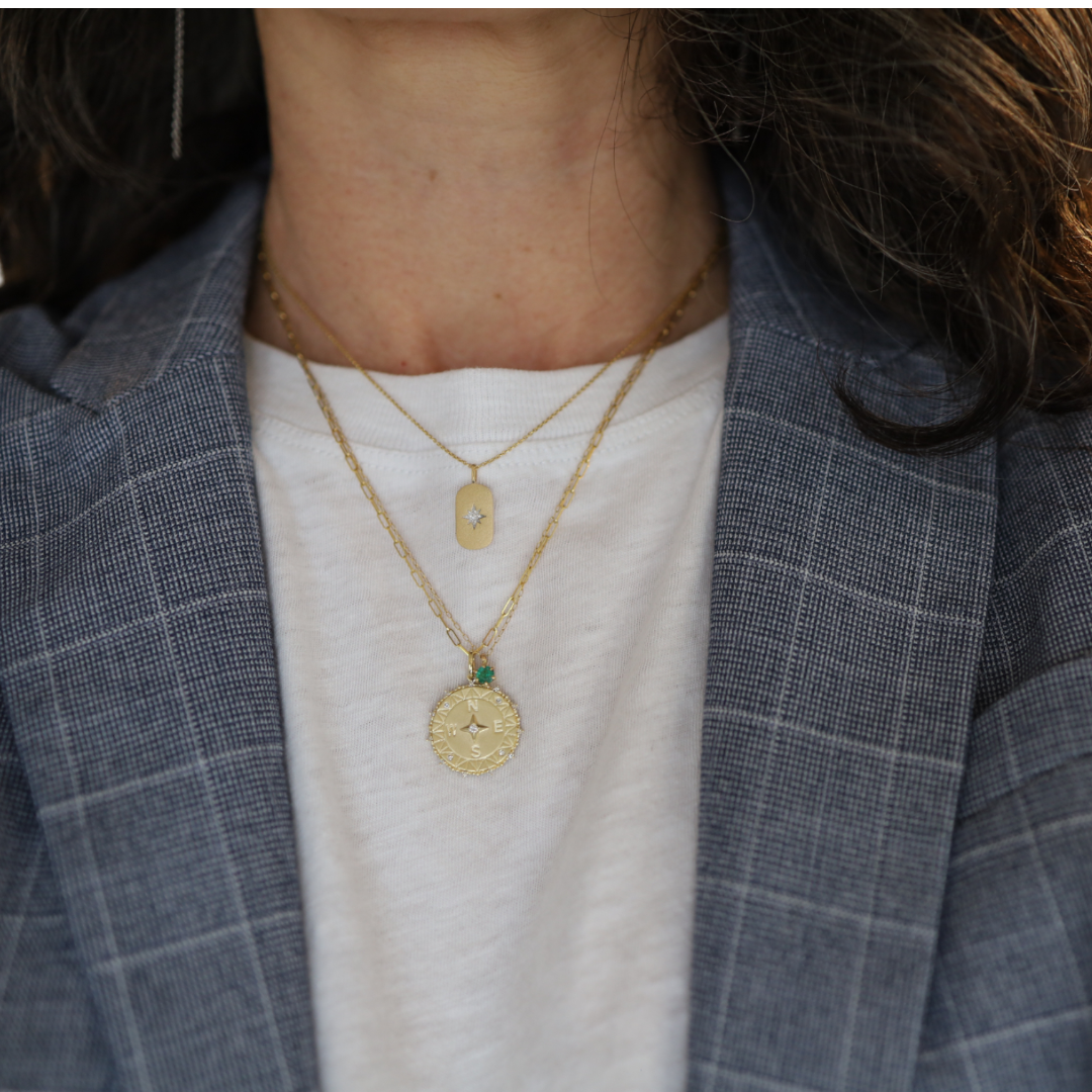 14k gold emerald pendant necklace from the 1990s featuring a vibrant green emerald gemstone.