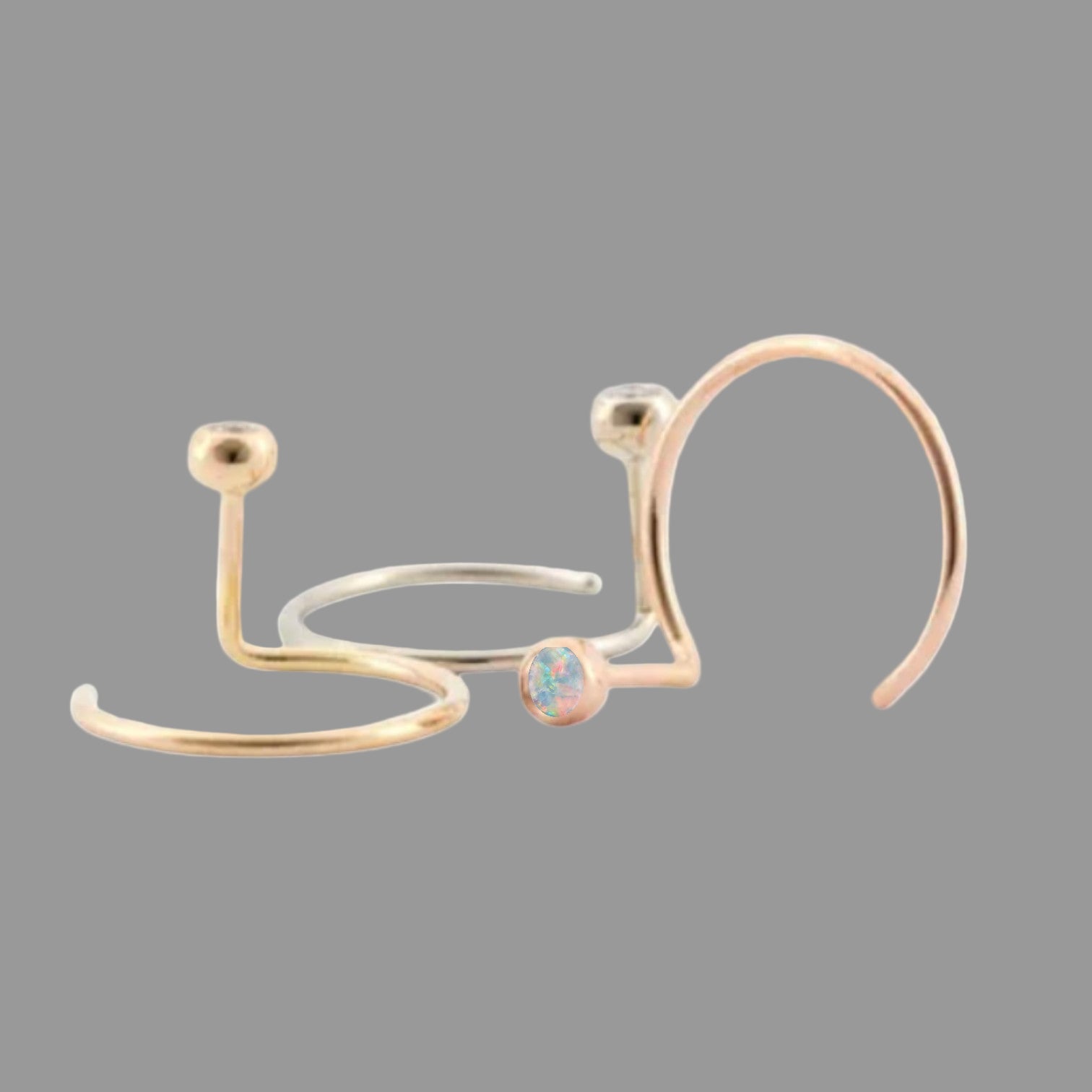 Petra Star 14k gold opal ear nut earring with a smooth, polished finish and vibrant opal gemstone.