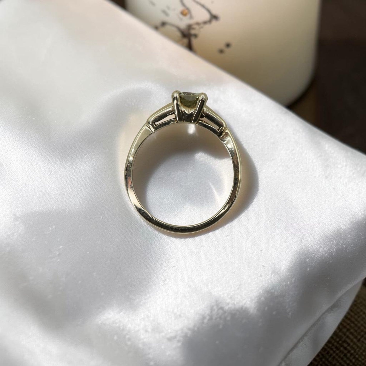 Light yellow diamond solitaire engagement ring with vintage-style setting, featuring a retro fancy cut diamond on a delicate band.