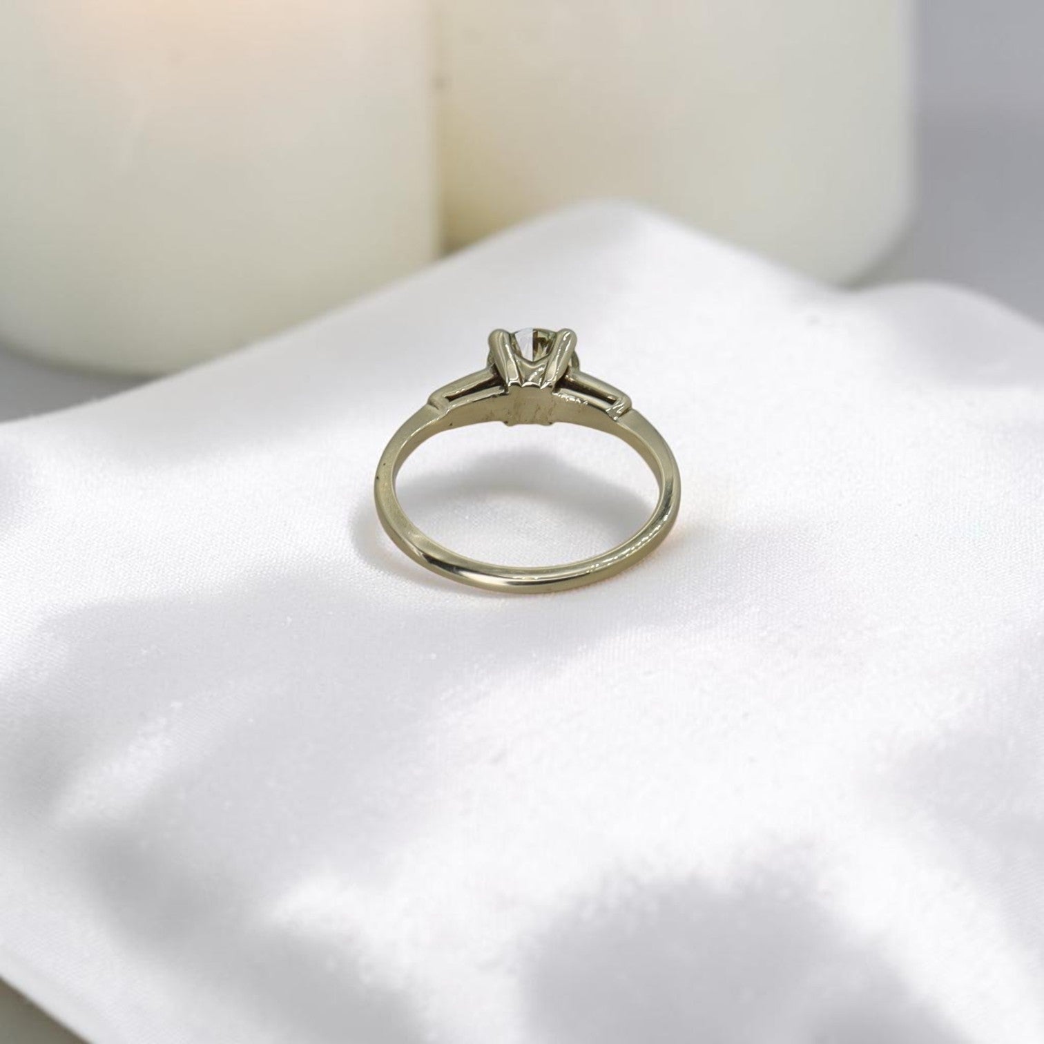 Light yellow diamond solitaire engagement ring featuring vintage-inspired design with a diamond accent, crafted by The Vintage Vault.
