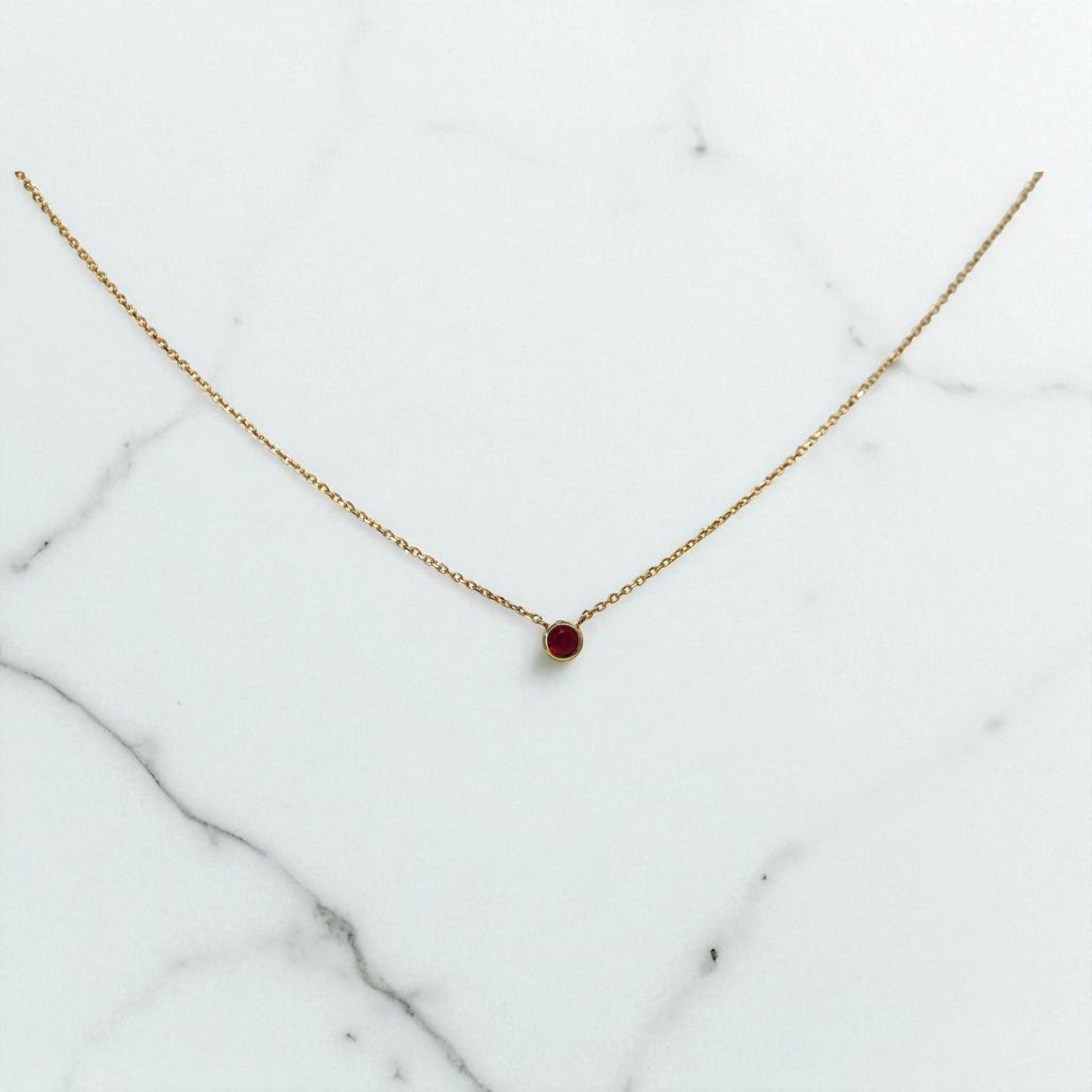 Petra Star ruby necklace featuring a vibrant red gemstone pendant on a delicate chain.
