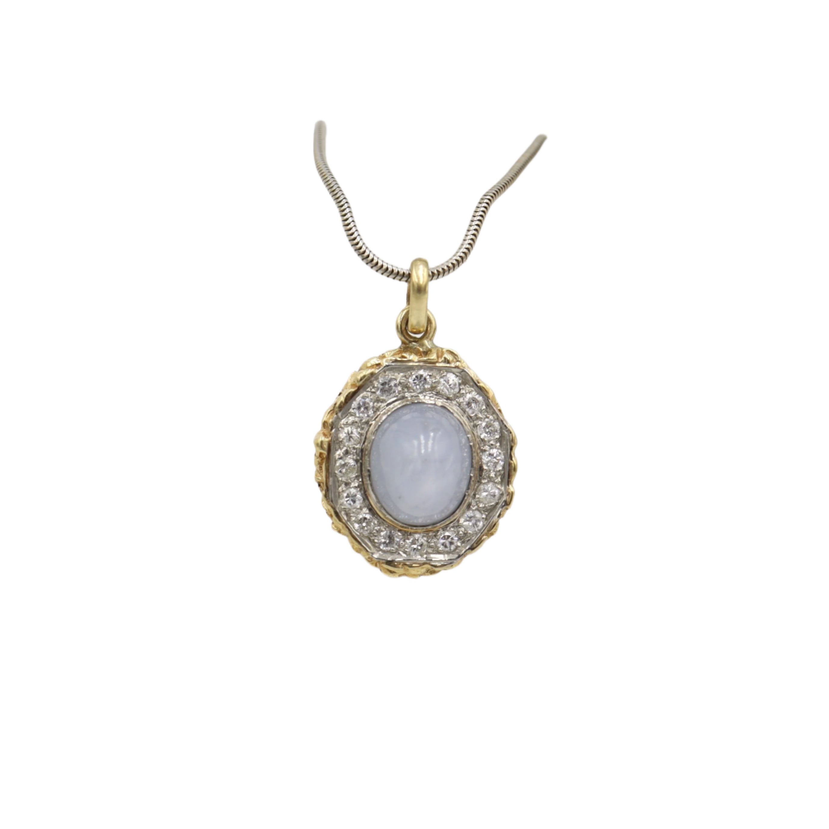 Star sapphire and diamond halo pendant featuring a central blue sapphire surrounded by sparkling diamonds, elegant jewelry piece.