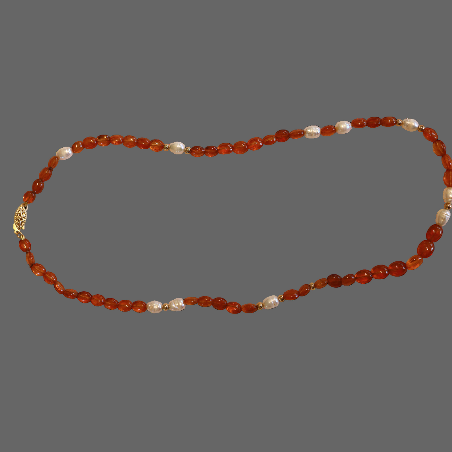 Necklace with orange beads and a gold clasp
