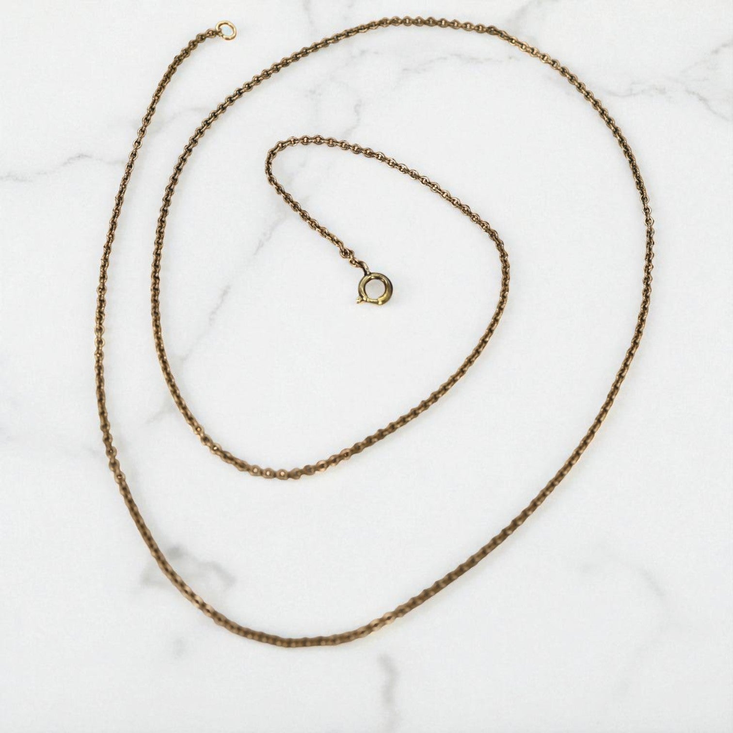Vintage 28-inch gold-filled curblink chain featuring classic interconnected links, showcasing a timeless jewelry style.
