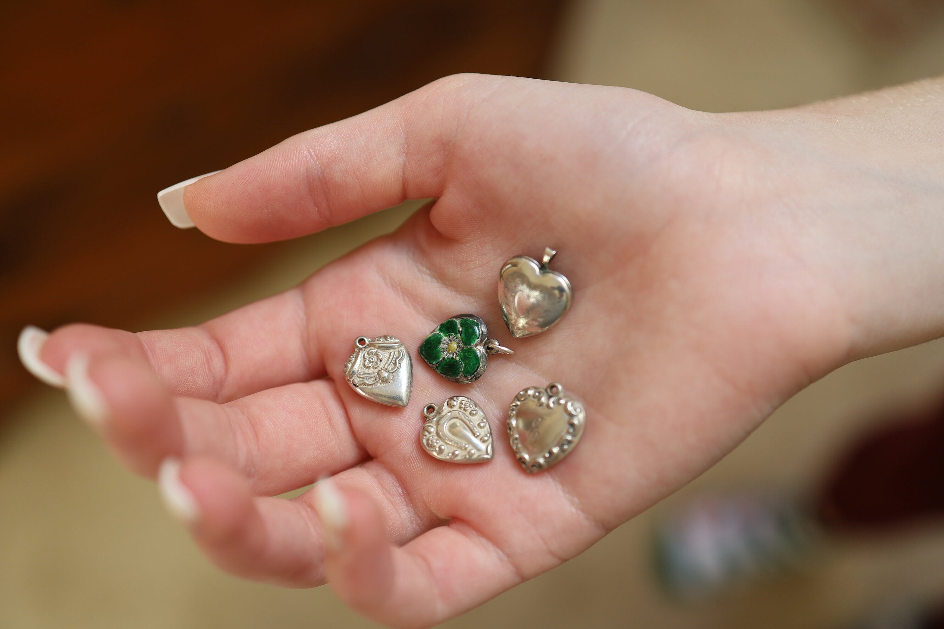 Art Nouveau silver puffy heart pendant with a locket design, featuring intricate detailing and vintage charm.