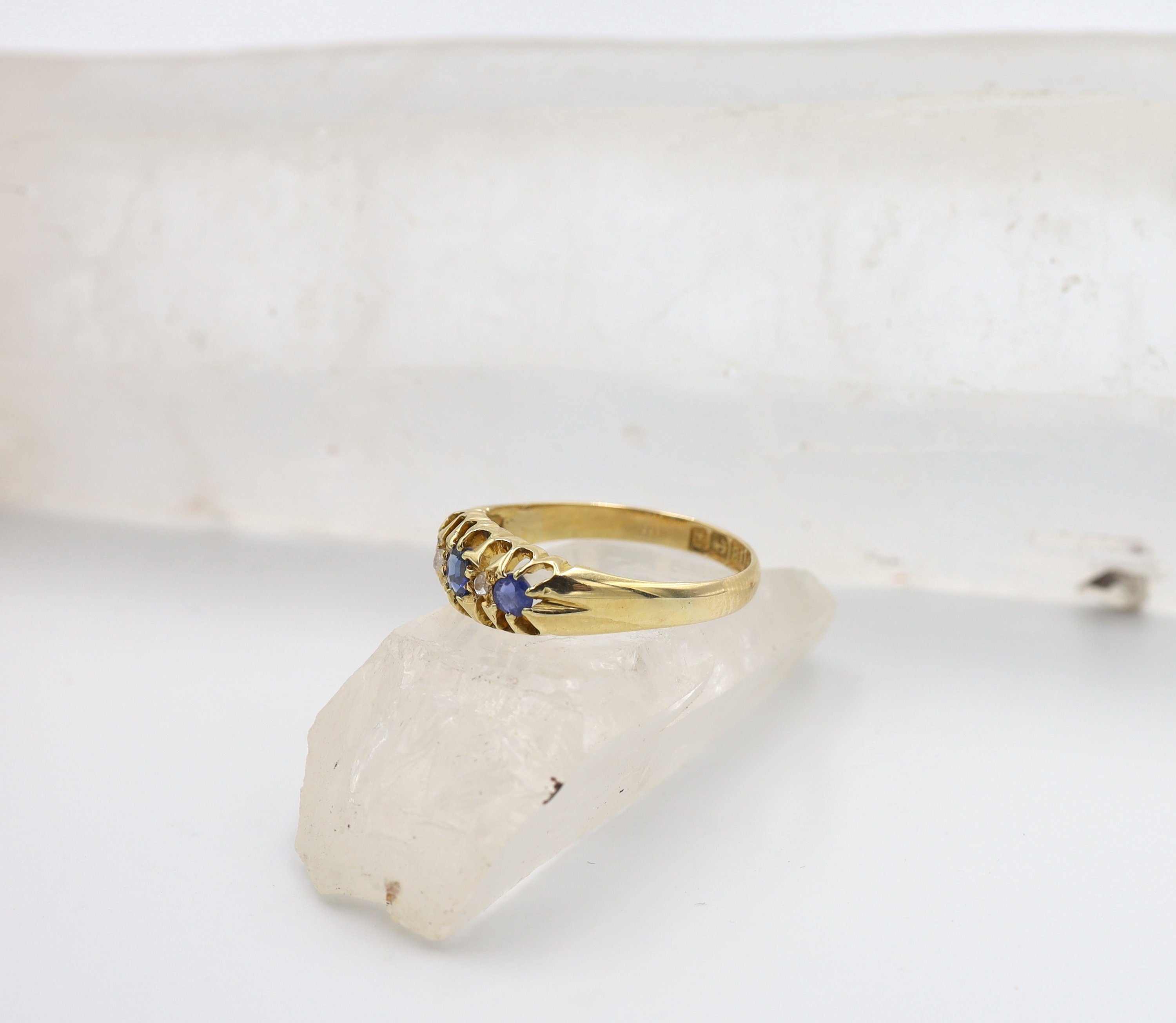Victorian sapphire and diamond band ring in 18k yellow gold with a classic Belcher design, featuring intricate gemstone details.