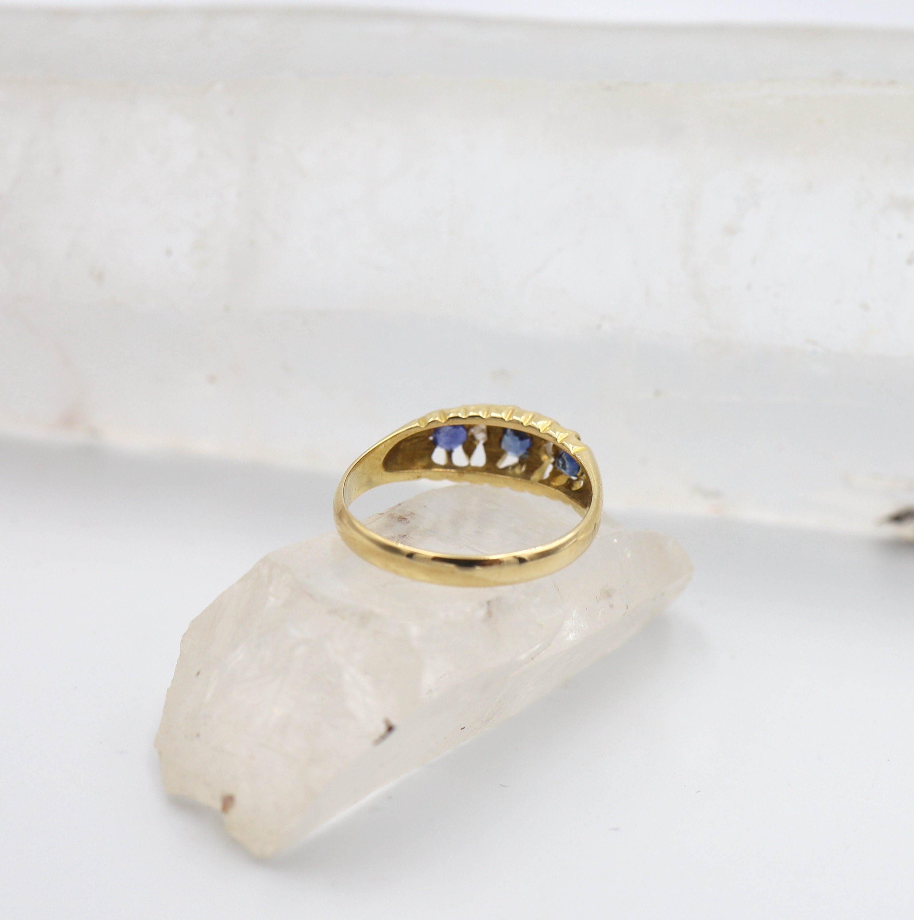 Victorian sapphire and diamond band ring in 18k yellow gold with a belcher style design, featuring intricate gemstone settings.