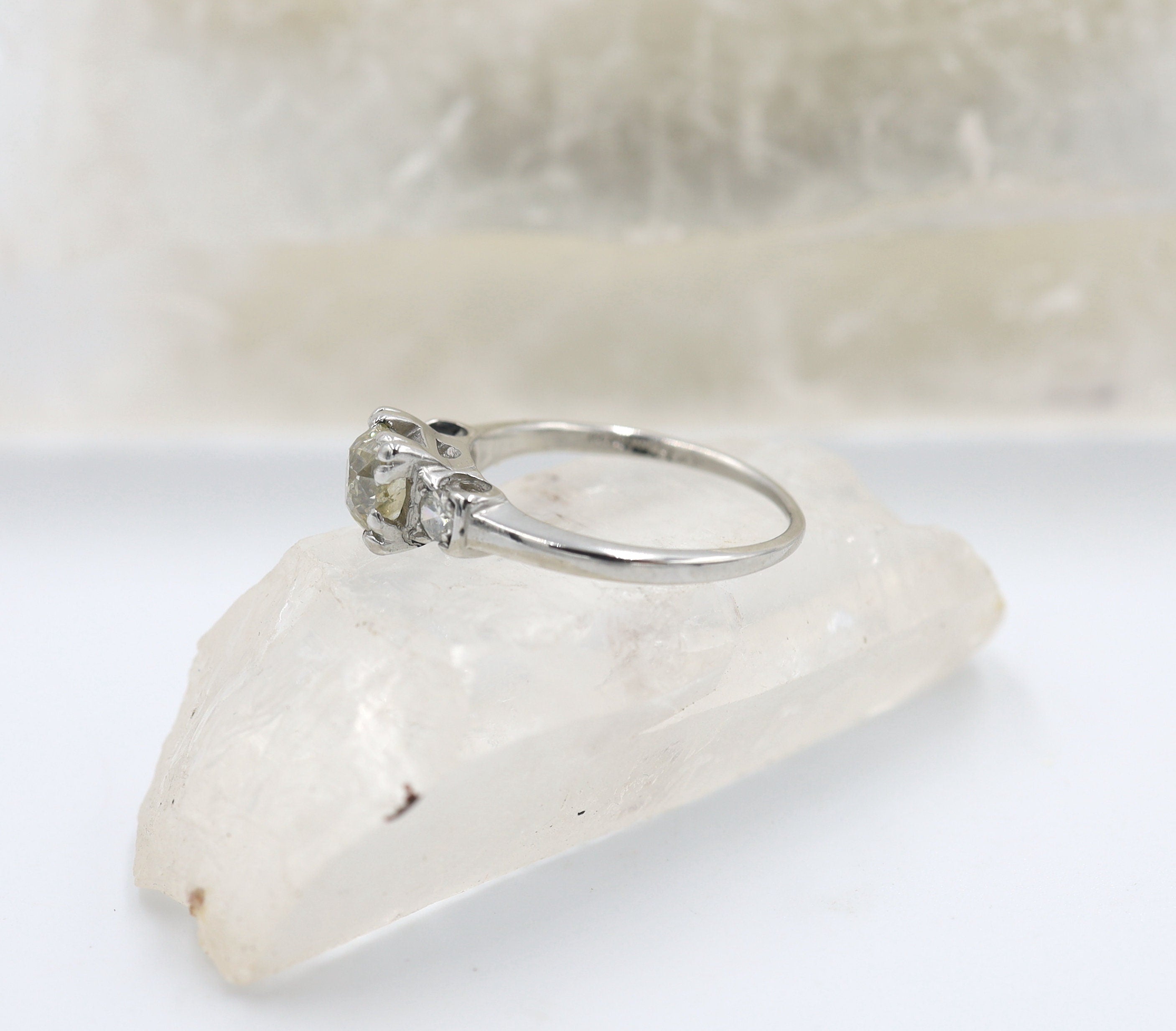 Vintage Art Deco platinum three-stone diamond engagement ring with old mine cut center and vintage illusion box setting by The Vintage Vault.