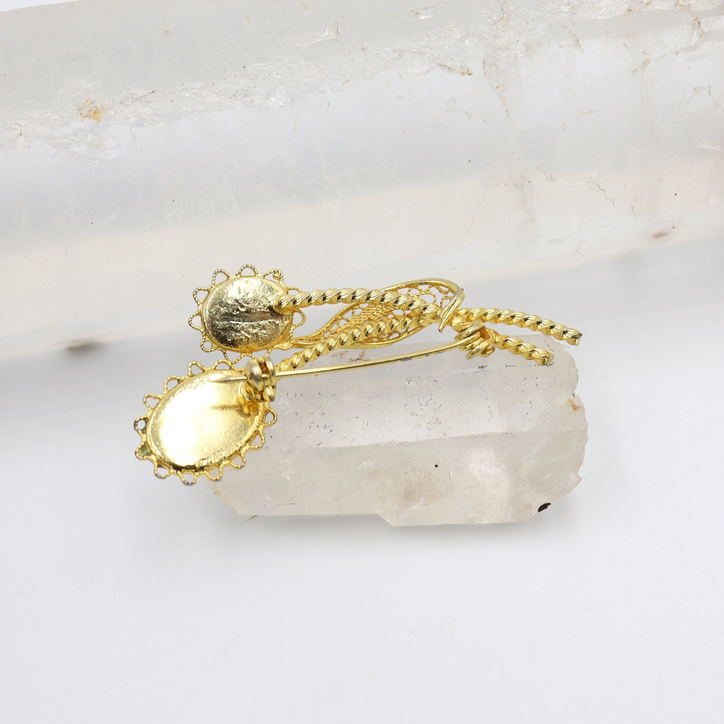 Vintage gold-tone costume jewelry brooch pin with intricate design, featuring a classic vintage style from The Vintage Vault.
