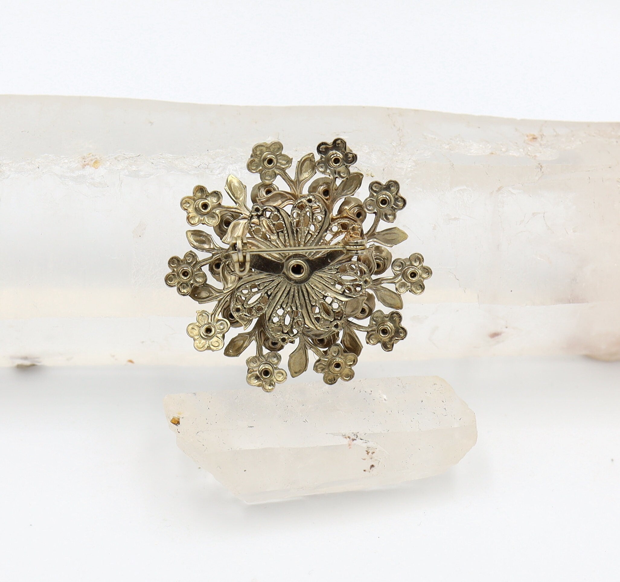 Vintage gold-tone Miriam Haskell-style costume jewelry brooch pin with intricate floral design and antique finish.