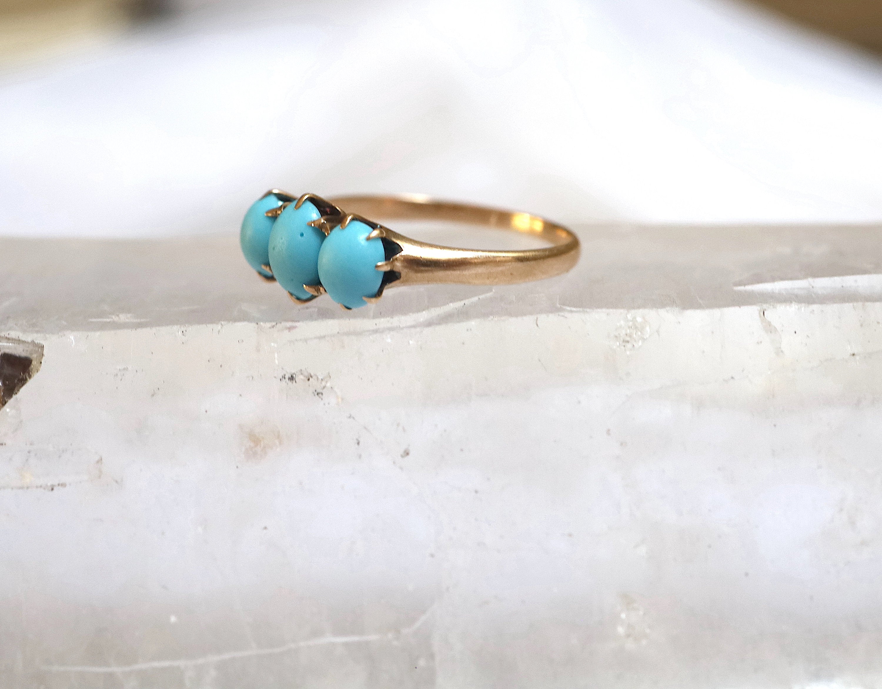 Victorian three-stone turquoise ring by The Vintage Vault featuring a detailed antique-style silver band and vibrant turquoise stones