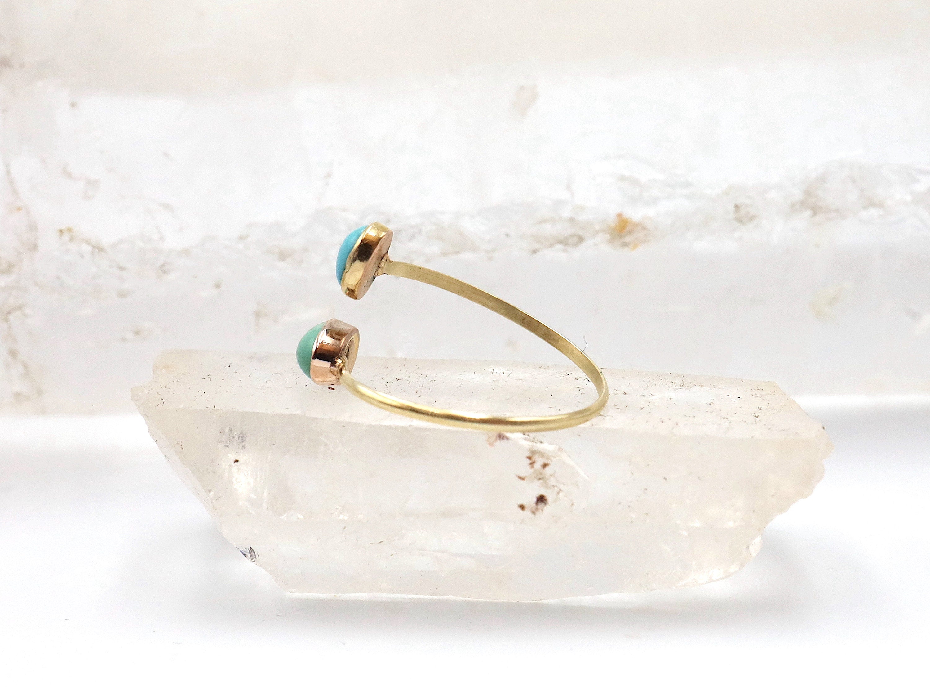 Victorian turquoise Toi et Moi ring by The Vintage Vault featuring two oval turquoise cabochons set in a vintage-style ring.