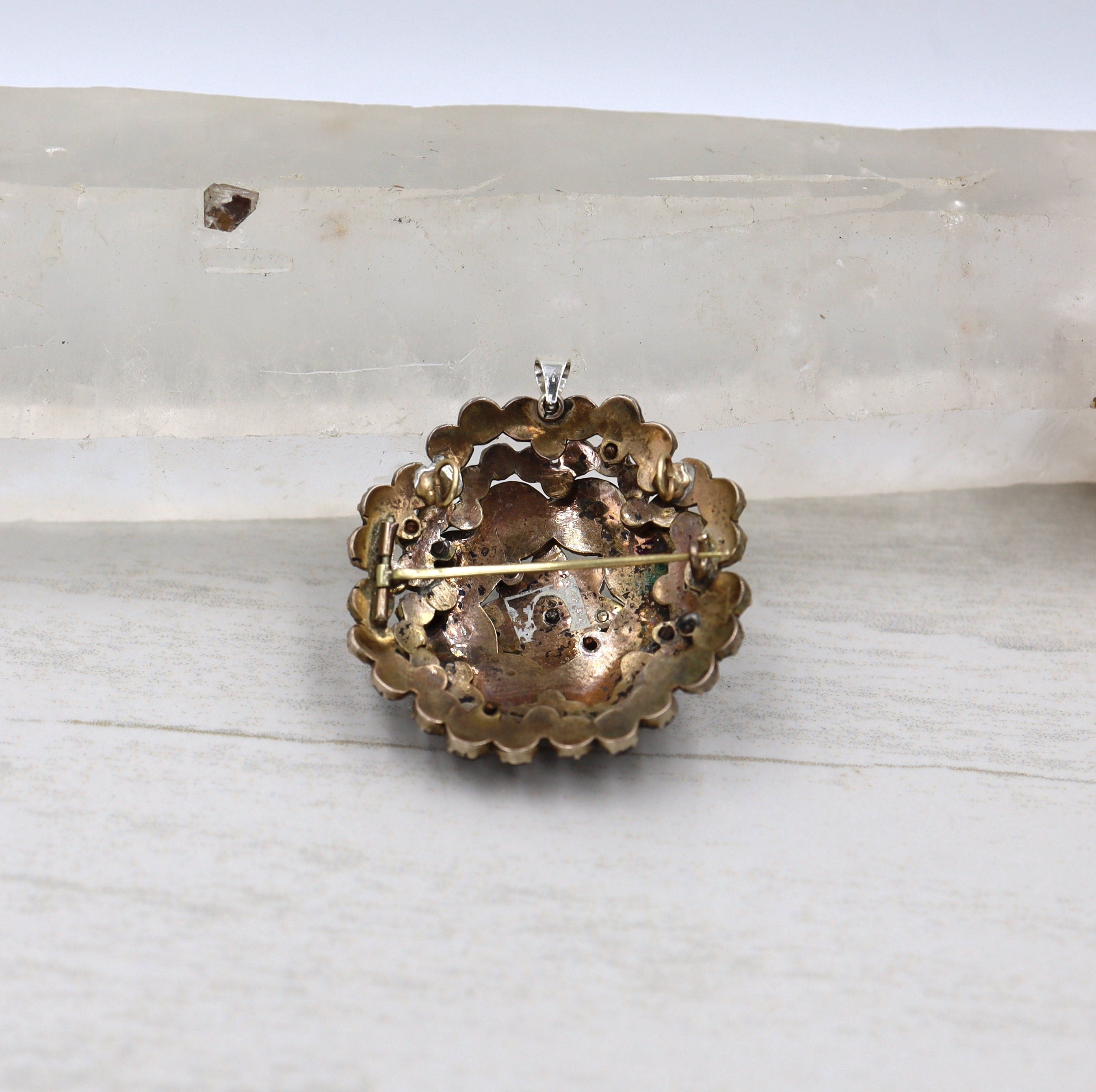 Authentic Early-Victorian Bohemian garnet pendant brooch with intricate metalwork and deep red gemstones.