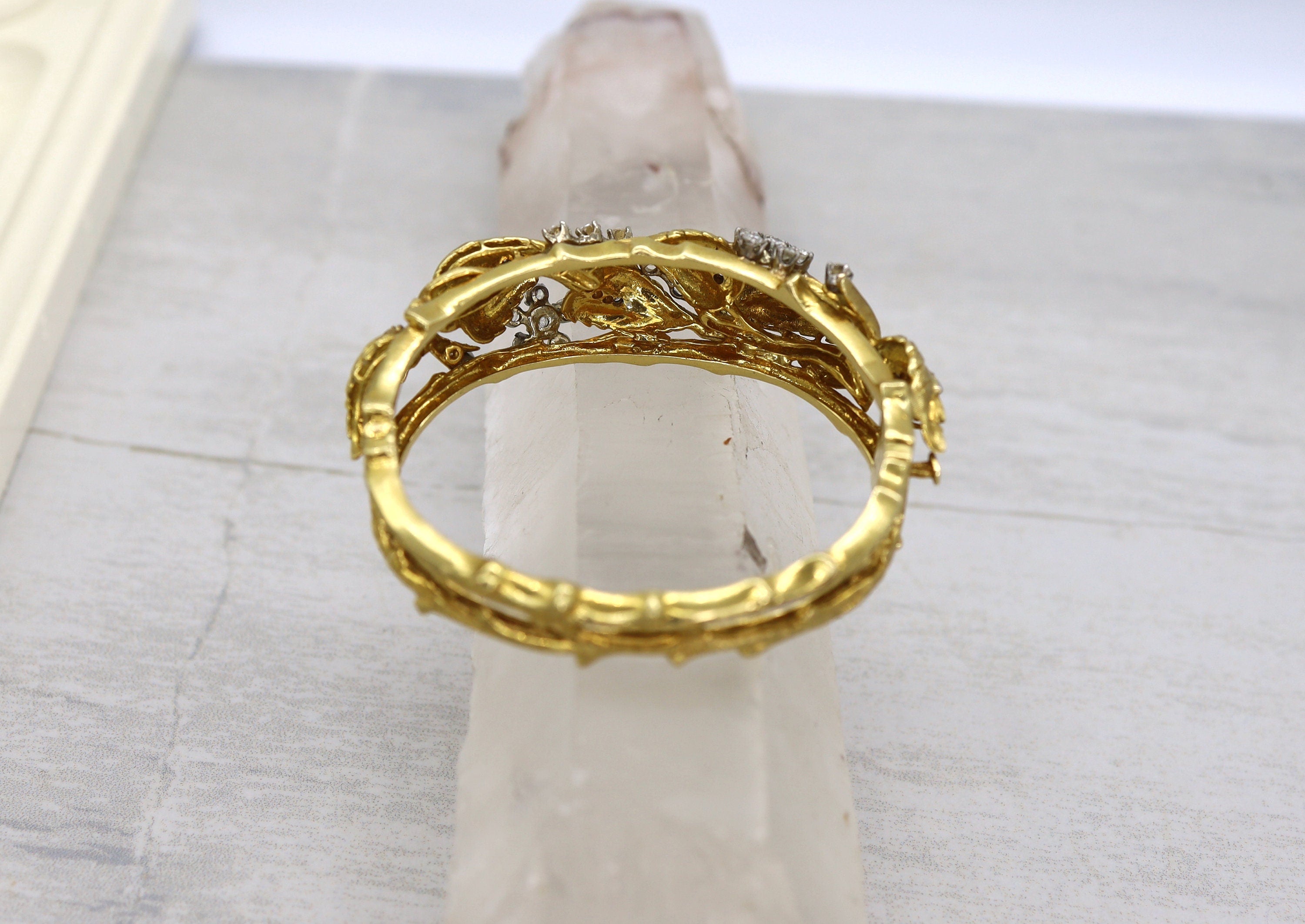Vintage 1950s Jack Gutschneider 18k diamond bangle bracelet with intricate design and sparkling diamonds, showcasing classic elegance.