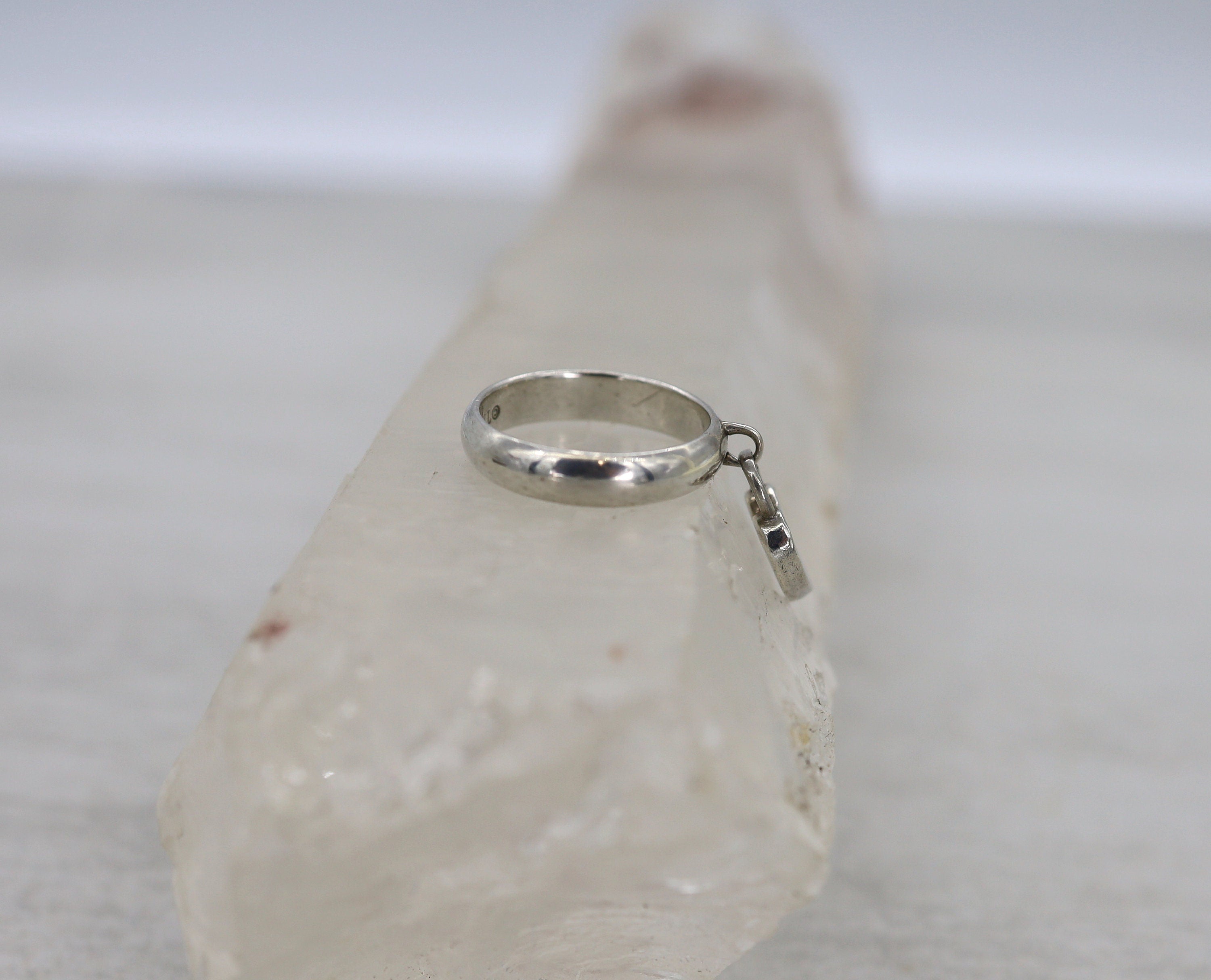 Silver Tiffany & Co. Heart Charm Ring in size 5.5, featuring a delicate heart design, styled by The Vintage Vault.