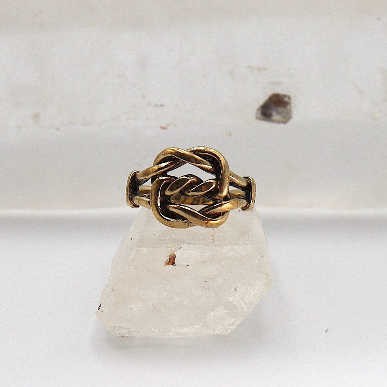 Vintage 9K gold lovers knot ring with hallmarked 1976 English design, featuring a classic love knot band style.