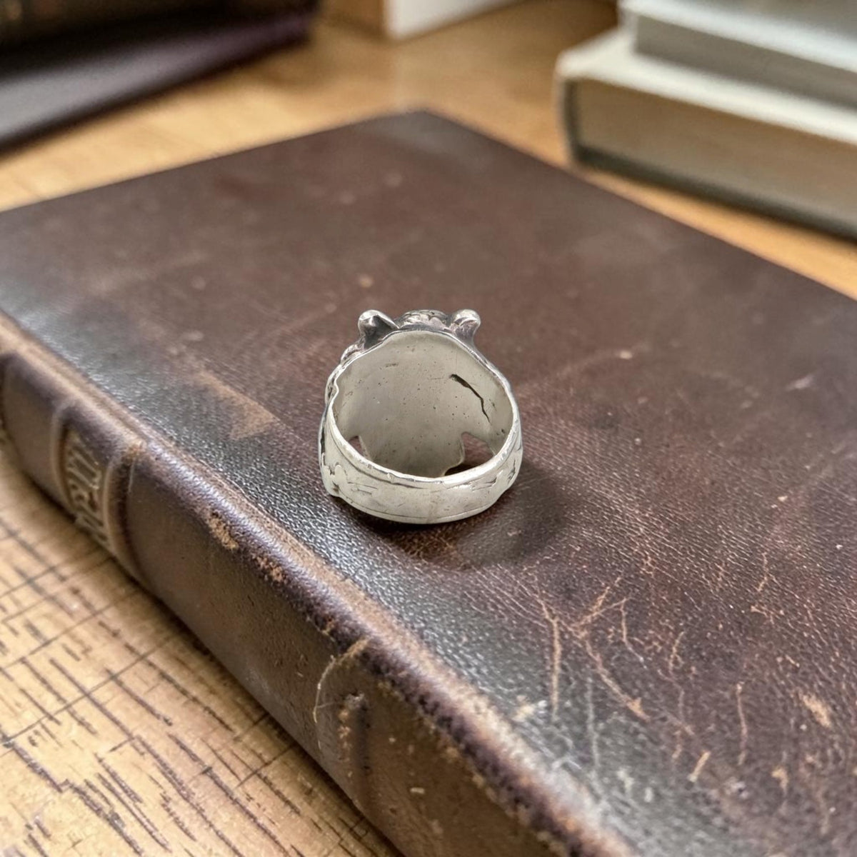 Antique silver satyr ring, back view showing the inside of the band