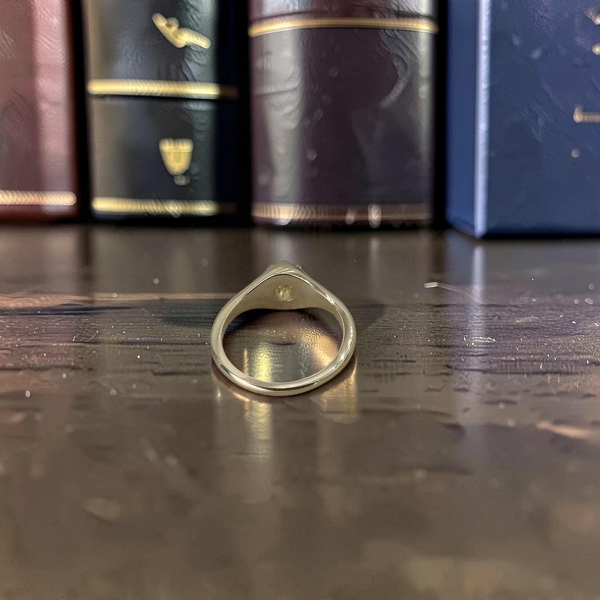 Back view through the band of a 14k yellow gold Belcher ring showing the low-set head