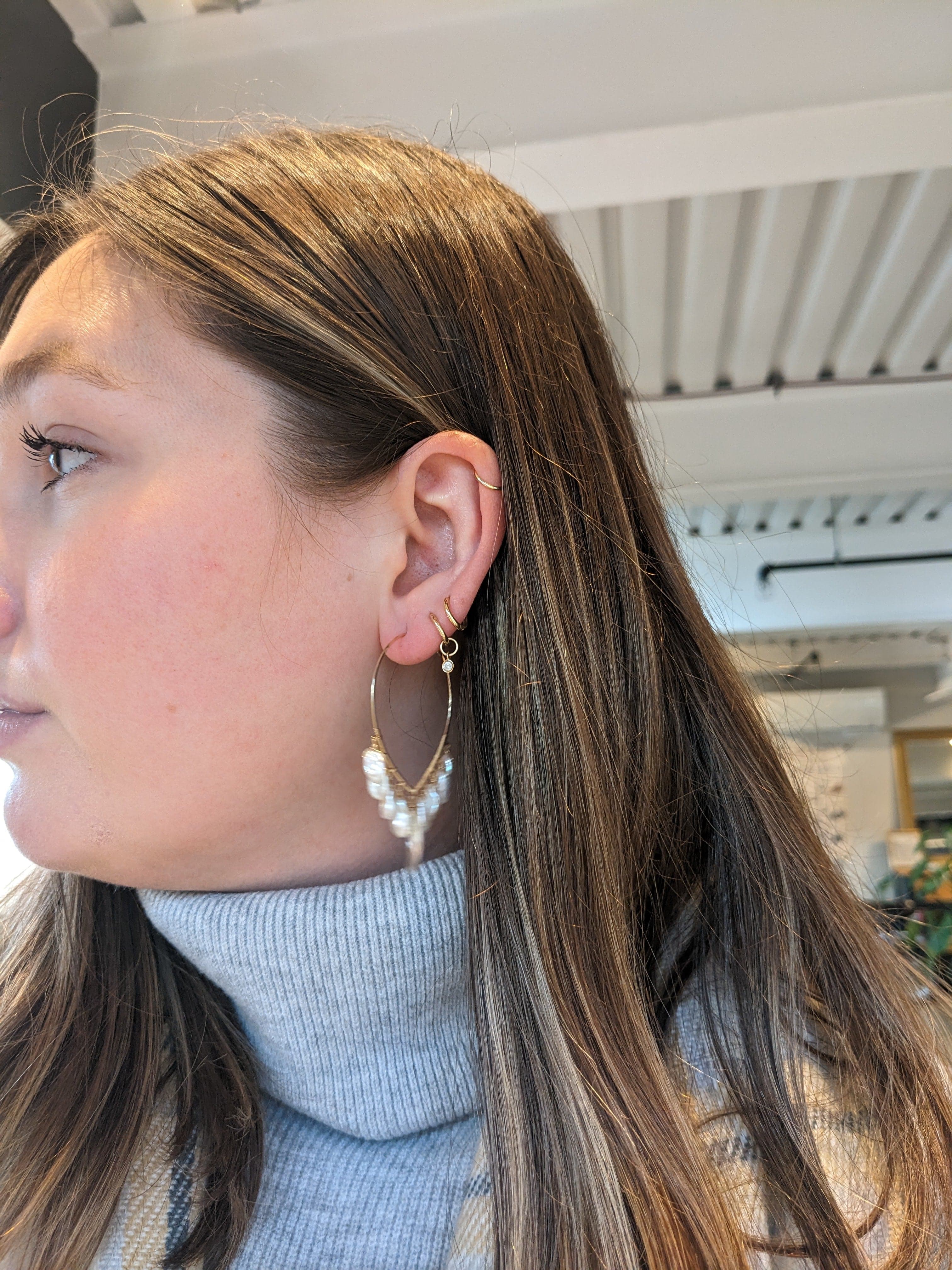 Dana Kellin pearl and crystal chandelier earrings with intricate silver settings and dangling gemstone accents.