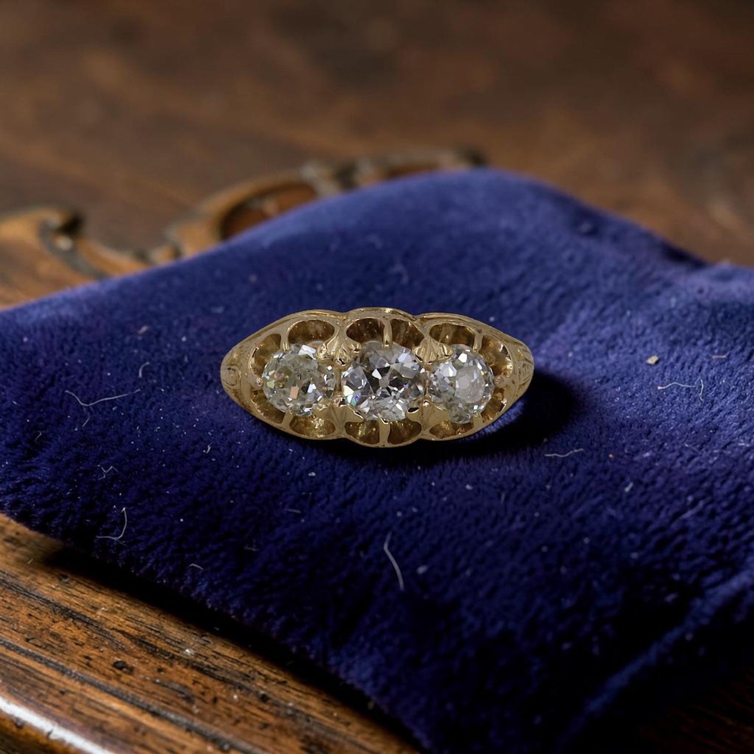 Antique Victorian 3 stone diamond ring in 18K gold with engraved details, featuring 0.93ct old mine cut diamonds, gypsy set trilogy band.