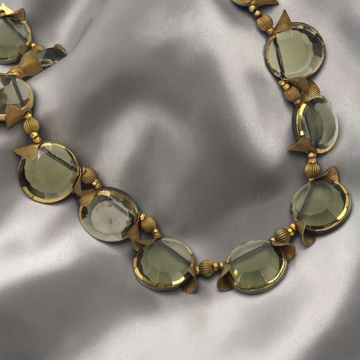 Detail of faceted smoky quartz coin beads hand-painted with gold edges on a vintage Miriam Haskell necklace