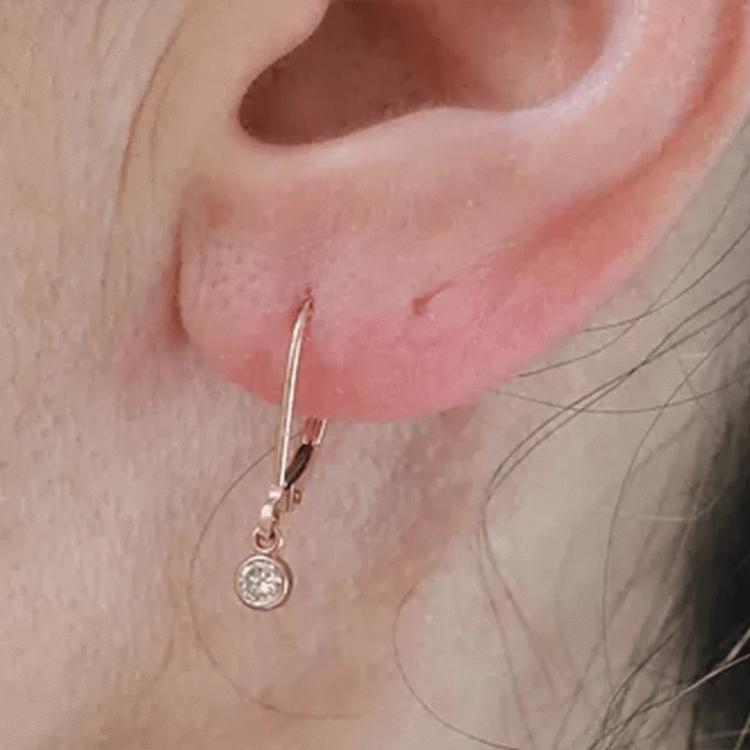 Petra Star Simply Bezels 14k rose gold diamond drop earrings with elegant pendant design and sparkling diamonds.