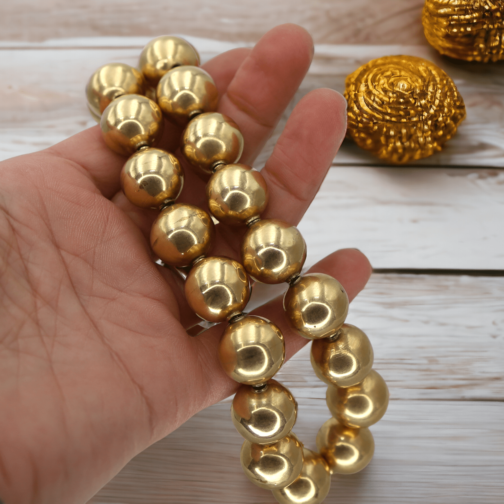 Antique Victorian 14k yellow gold bead necklace with intricate bead details and vintage design, displayed on a neutral background.