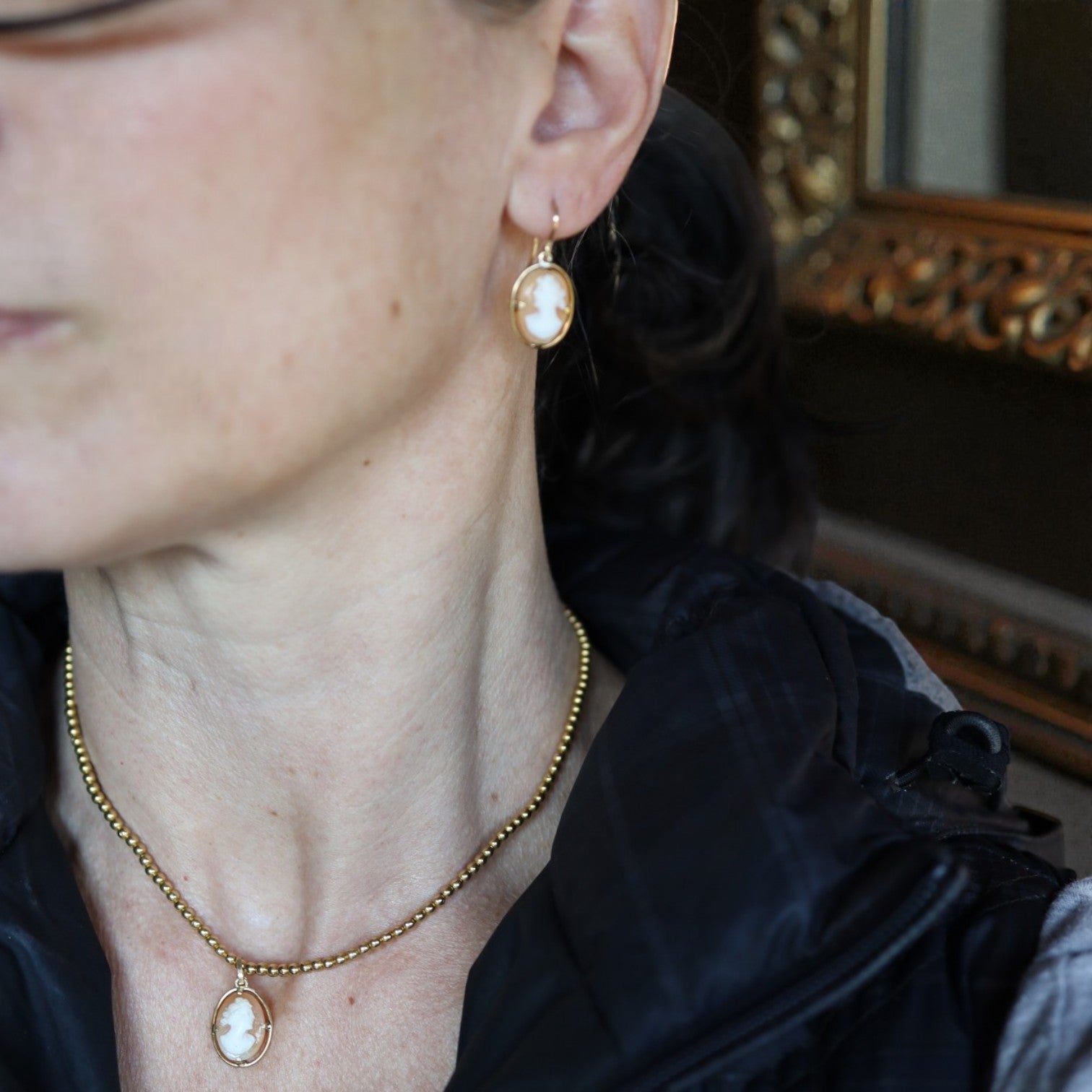 Victorian shell cameo earrings in 18k yellow gold by Petra Star, featuring intricate carved shell designs.