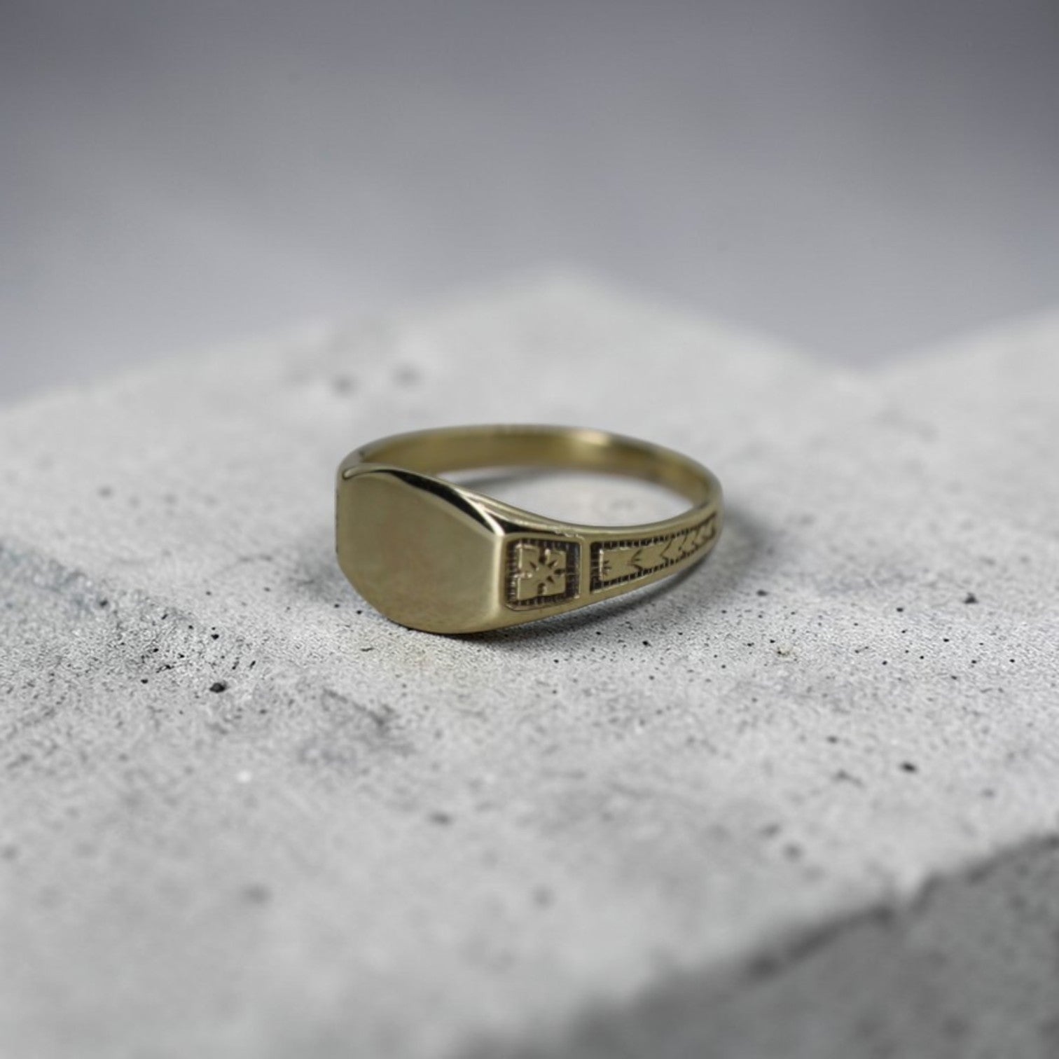 Edwardian Ostby & Barton signet ring in 10k yellow gold worn on pinky finger, vintage jewelry with classic design.