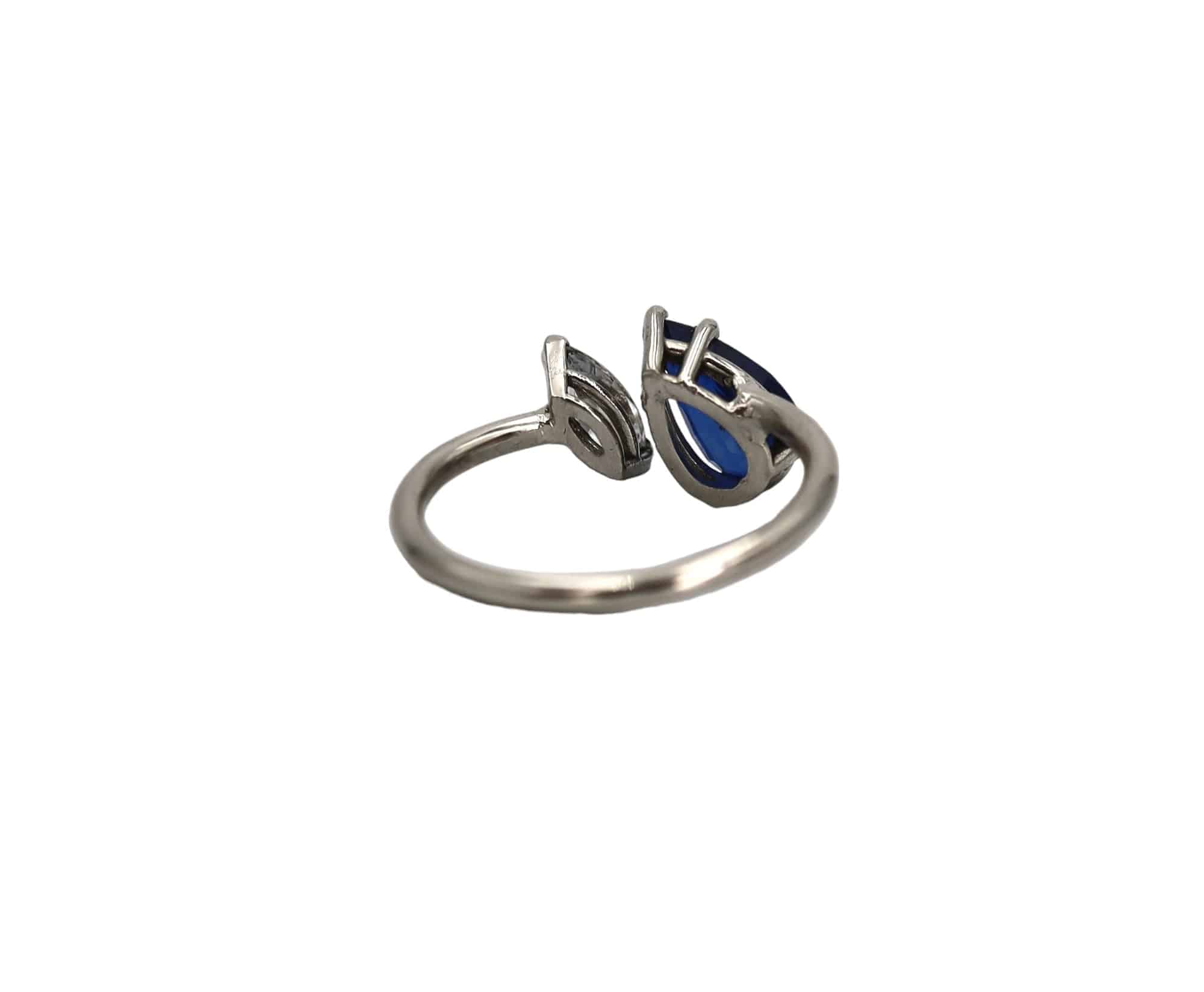 Platinum pear-shaped sapphire and marquise diamond ring by Petra Star, vintage gemstone statement jewelry with intricate design.
