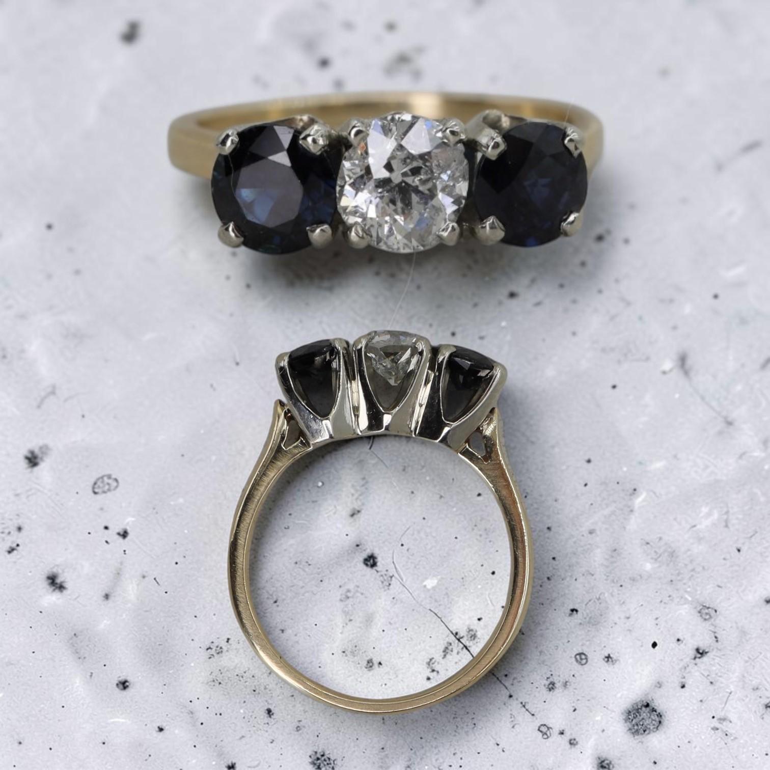 Close-up of the J. Ruffo Three Stone Ring by PS, featuring three sparkling gemstones set in a sleek gold band.