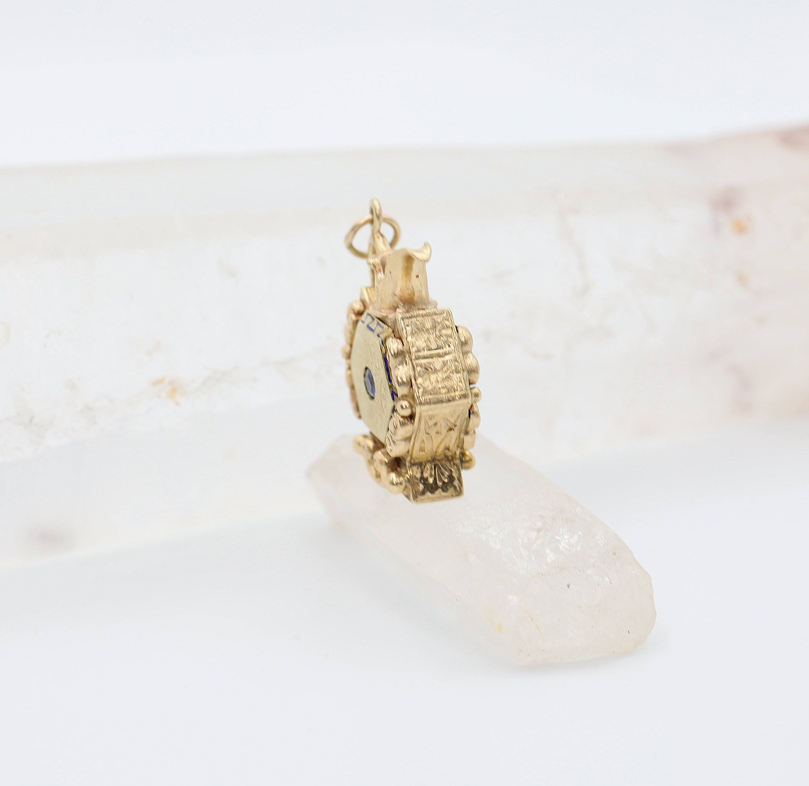 Antique 14k gold pitcher charm pendant with intricate detailing, crafted by The Vintage Vault, displayed on a neutral background.