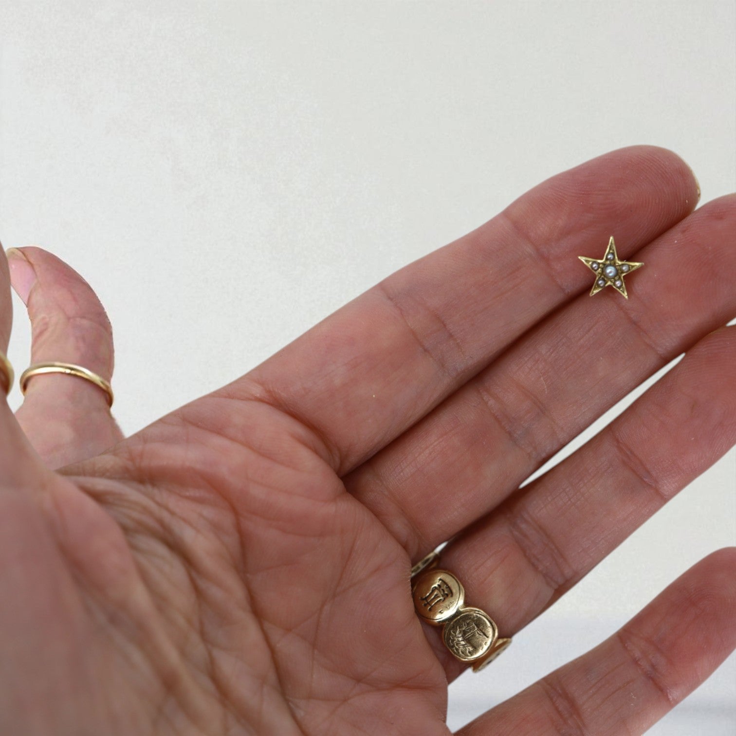 Single Victorian star earring with pearl detail in 14K gold from The Vintage Vault, showcasing elegant antique-inspired jewelry.