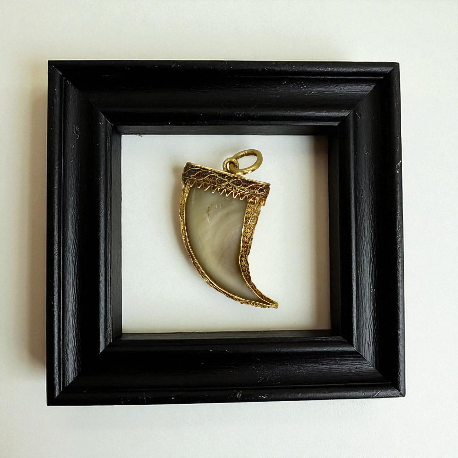 Antique Victorian British Raj tiger’s claw pendant in 20k gold with intricate cannetille detailing, vintage jewelry piece.